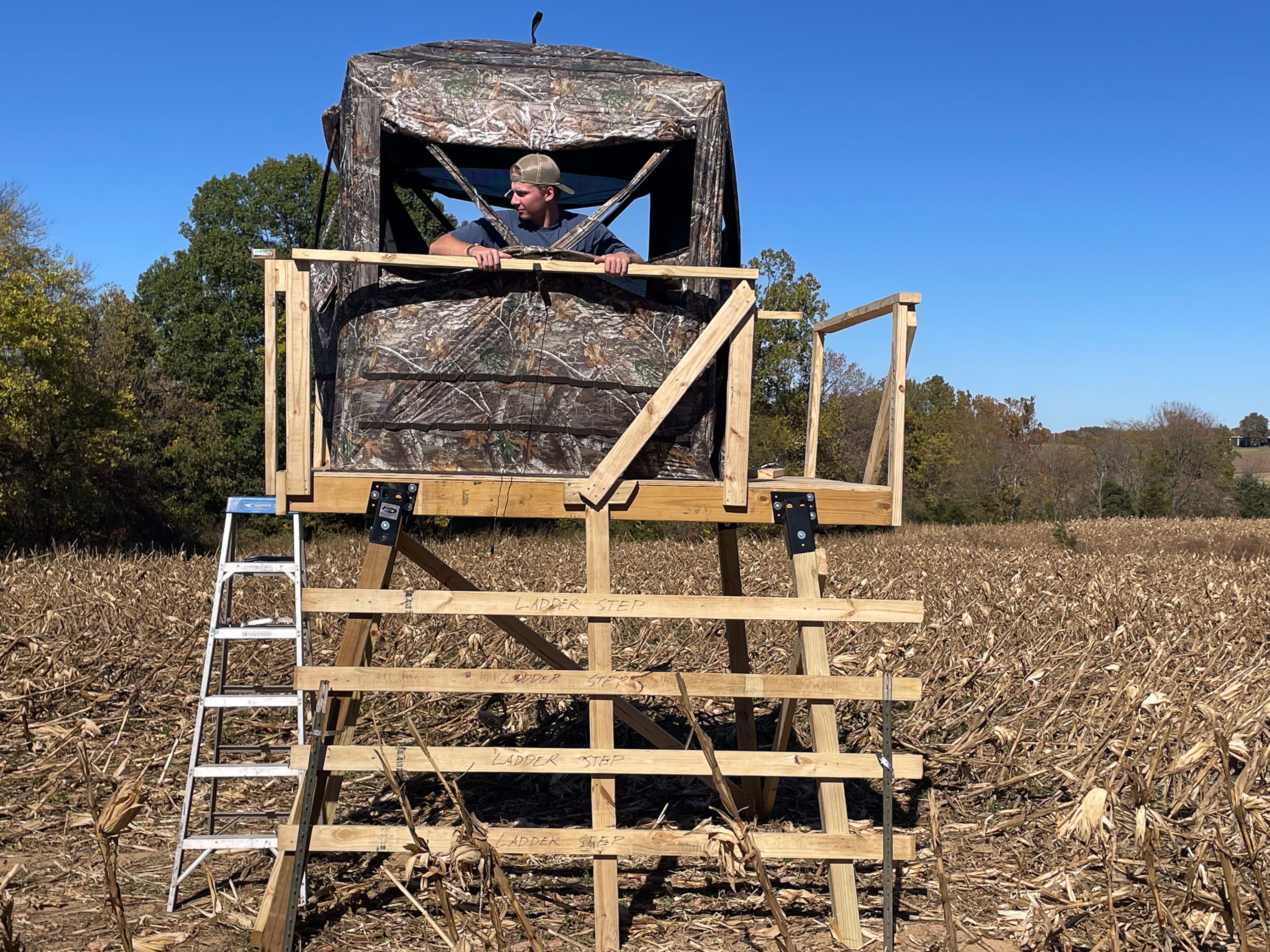 Bryson Klunk looks out of the deer stand that he built for the season for the season.