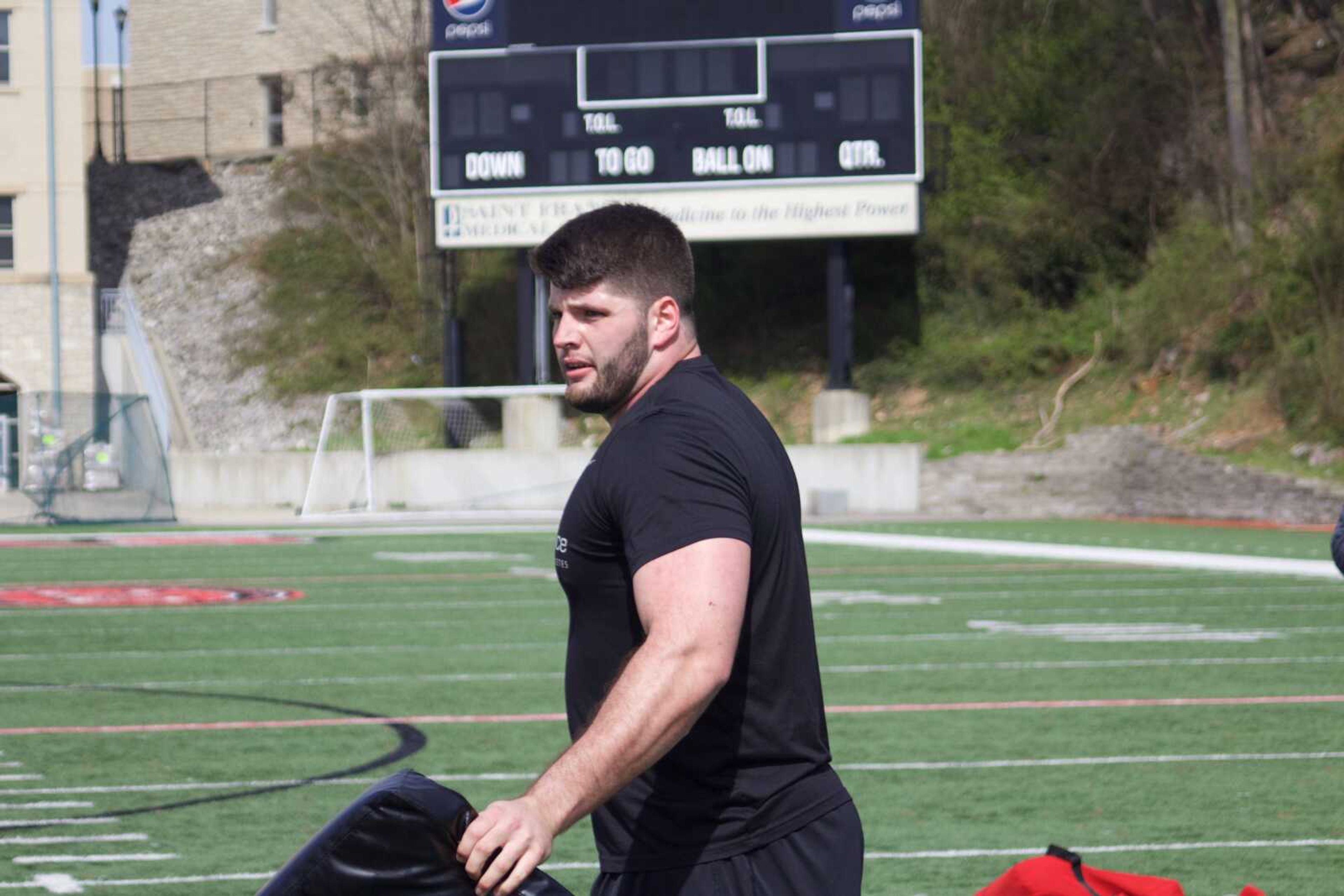 Senior offensive lineman Drew Forbes prepares to hold a bag for position drills during Southeast's pro day on March 26.