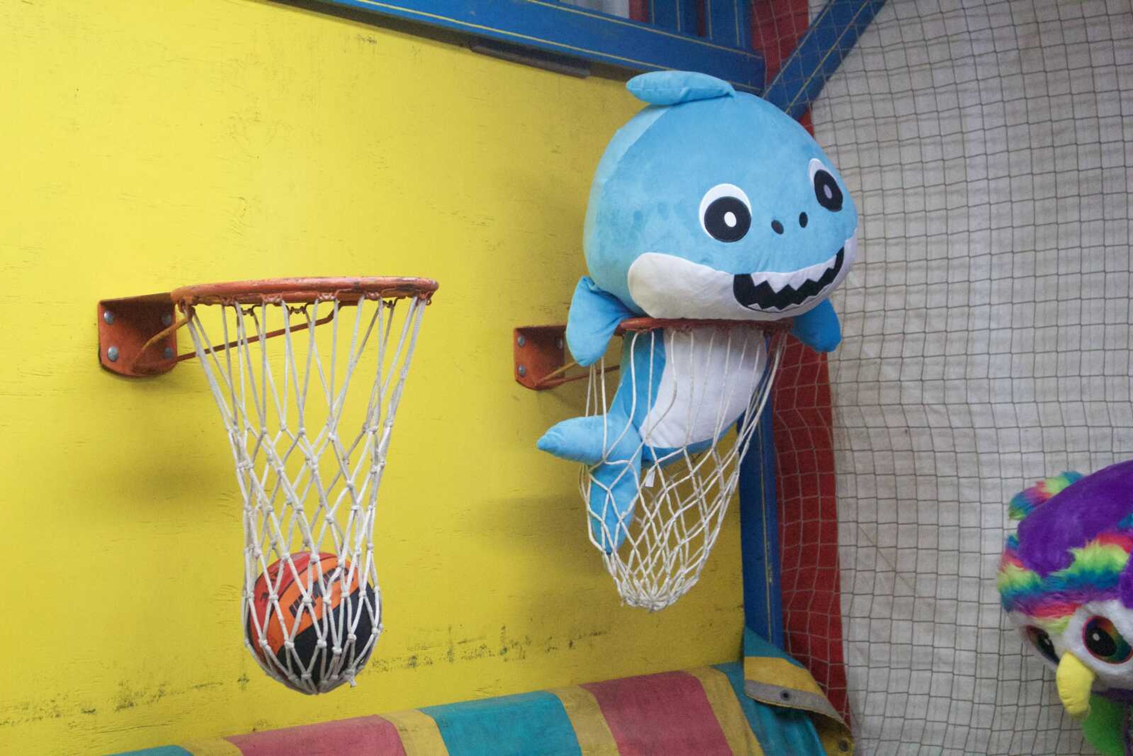 A shark stuffed animal sits propped inside a basketball hoop at a booth at the SEMO District Fair on Wednesday, Sept. 11.