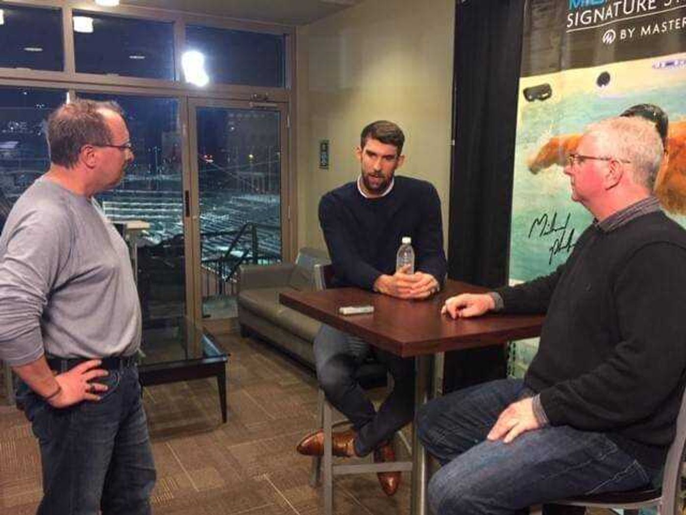 Tom Davis (left) interviews 23-time Olympic Gold Medalist Michael Phelps.