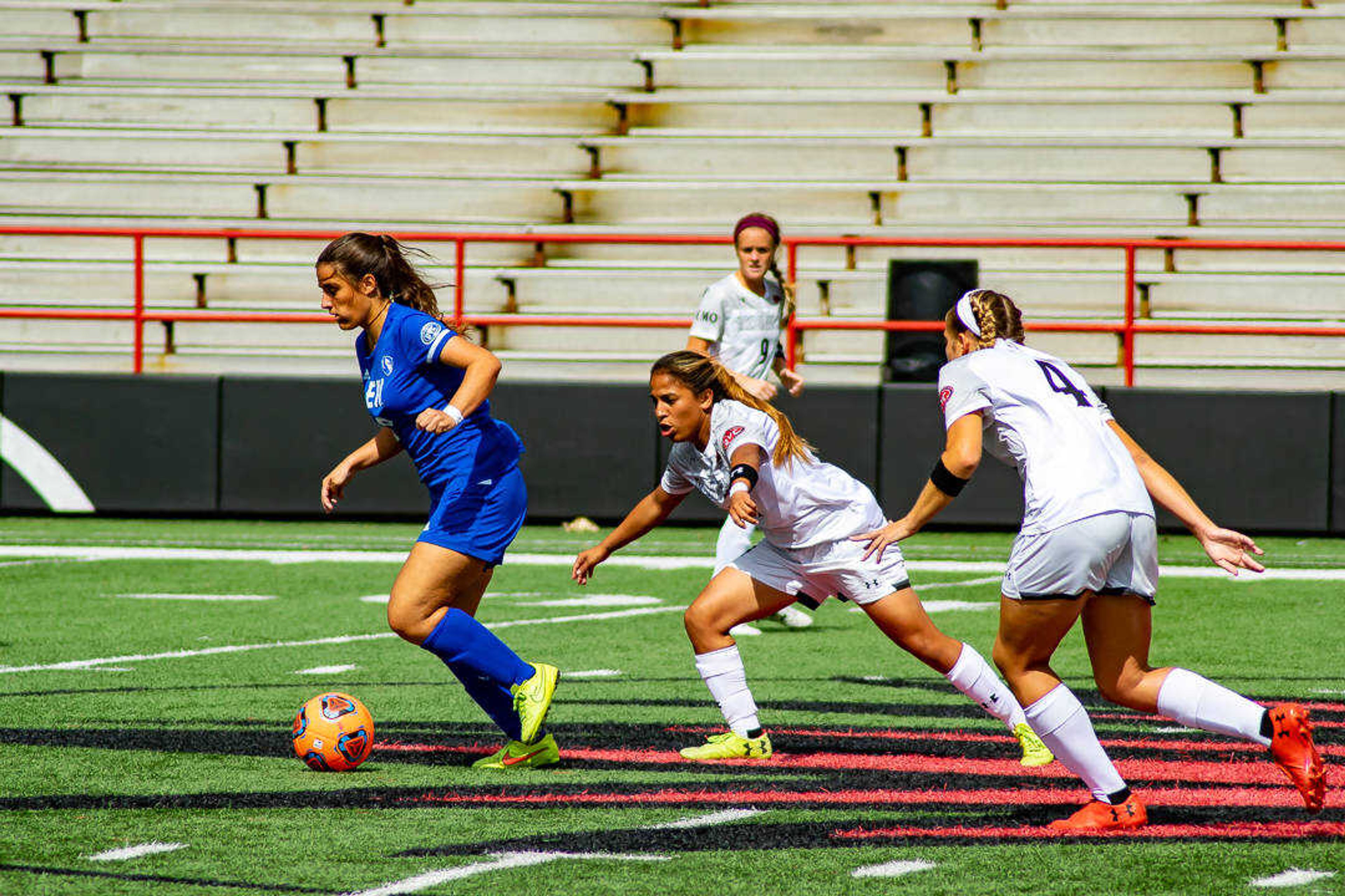 Midfielders Esmie Gonzales (middle) and Hannah Compernolle (right) pursue an Eastern Illinois player, Sept. 22 at Houck Field.