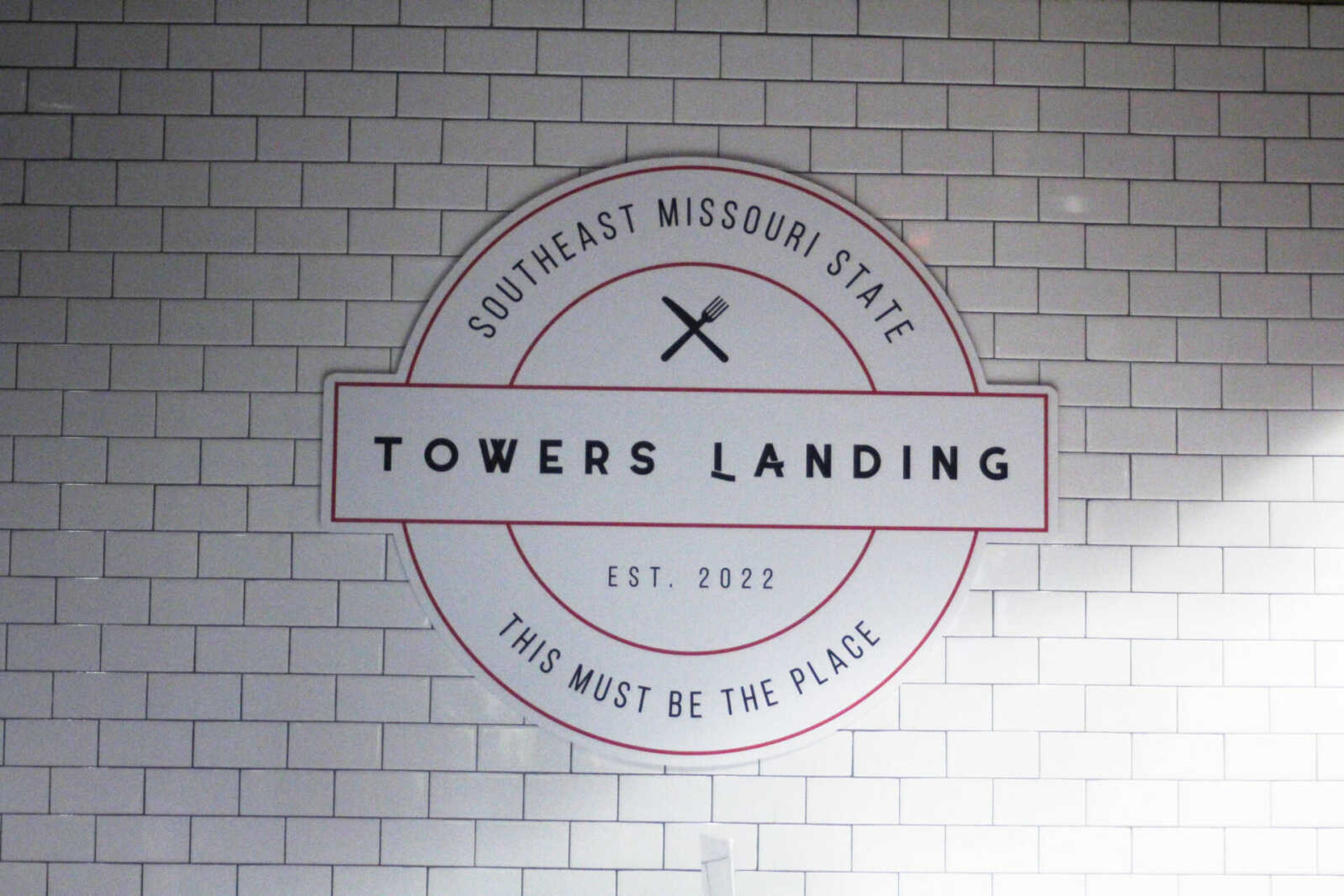 The sign leading to Towers Landing hangs on the wall welcoming students.