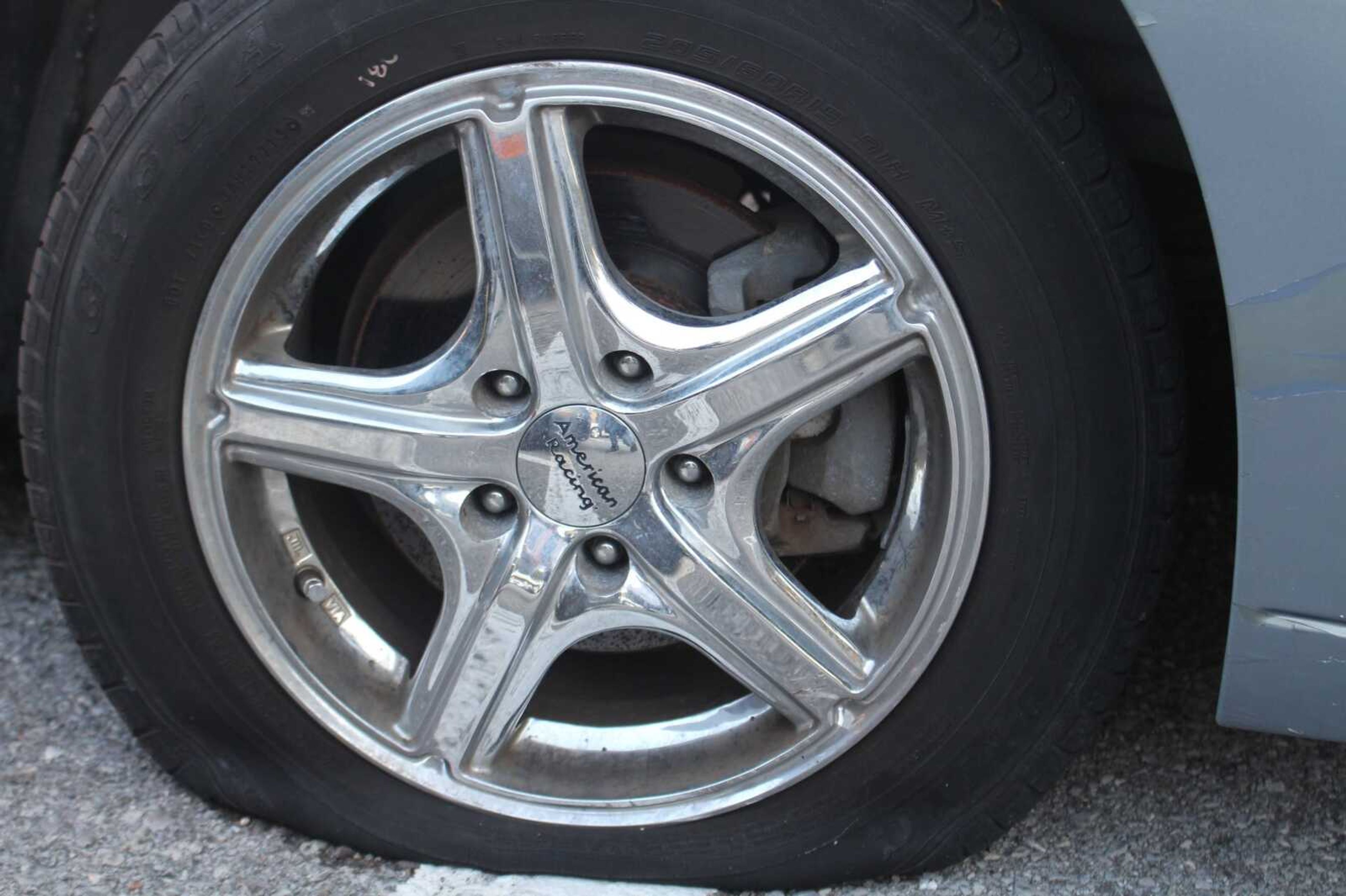 This car was found sitting on its rim after vandals punctured the tires and damaged paint to this car and at least 16 others.
