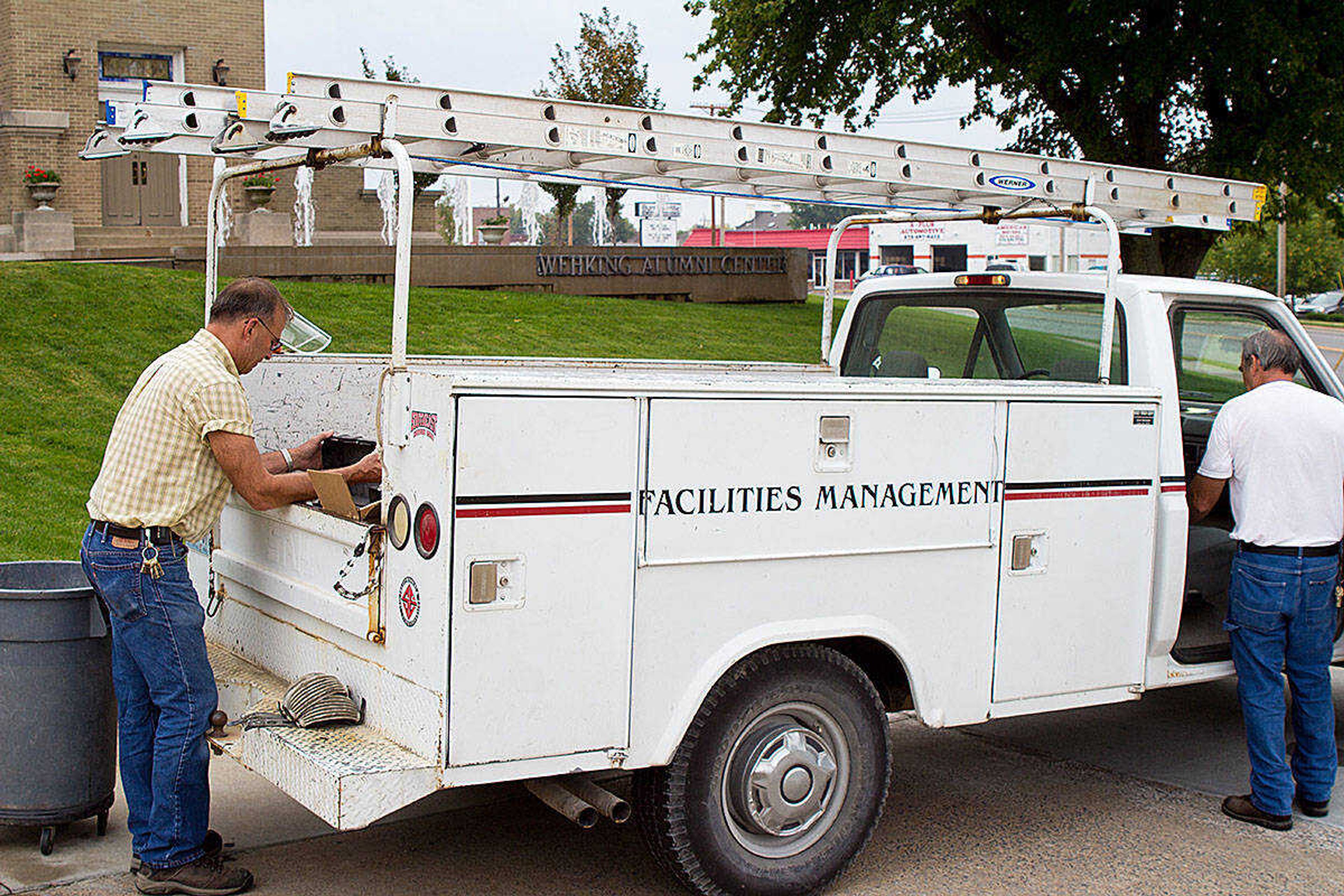 Facilities Management employees pack up their truck after doing maintenance at the Alumni Center. Photo by Paul Stokes