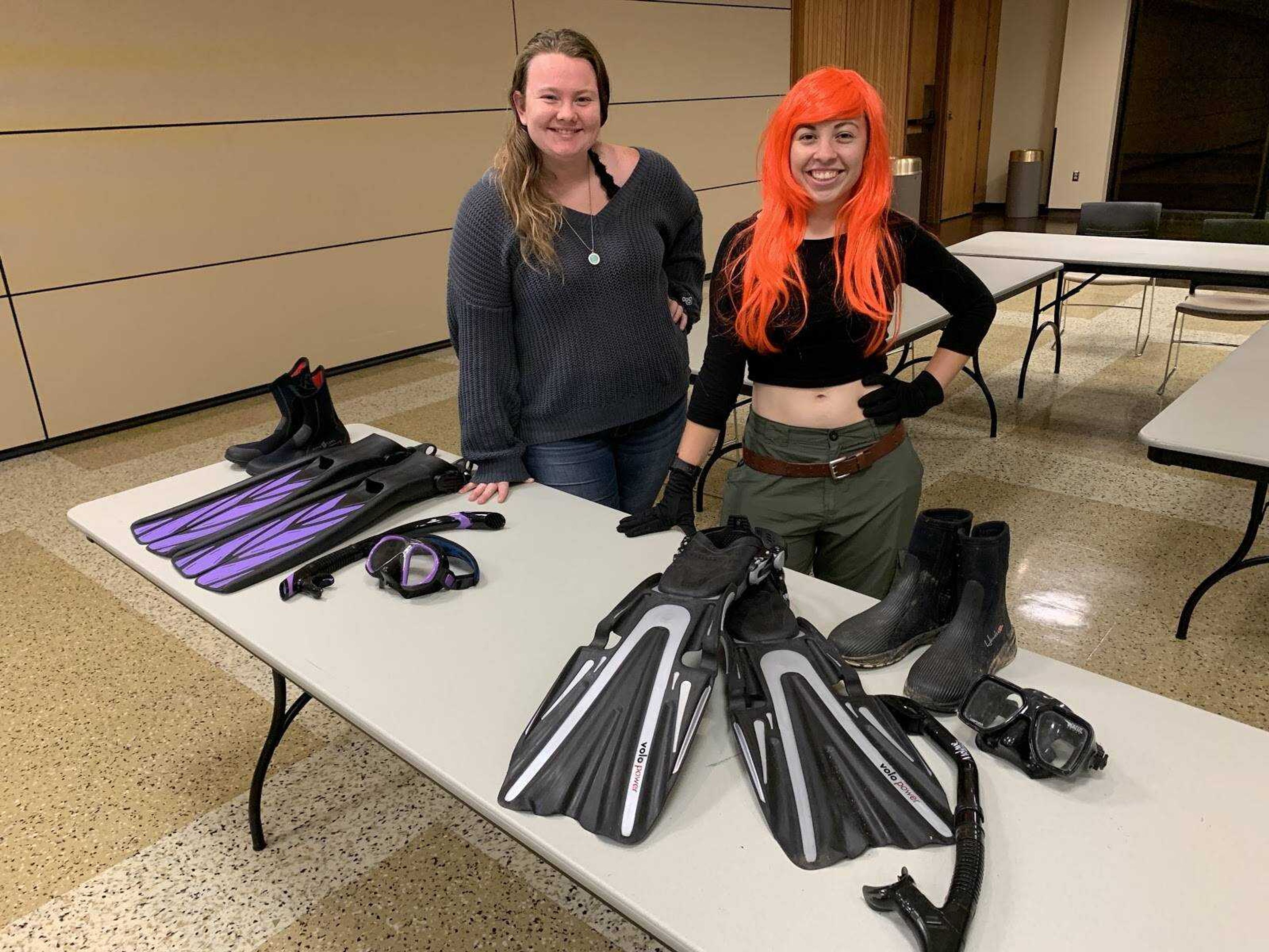 President, Amanda Milbrandt (left) and Vice President, Tori Wright stand behind their scuba gear in their usual meeting room.