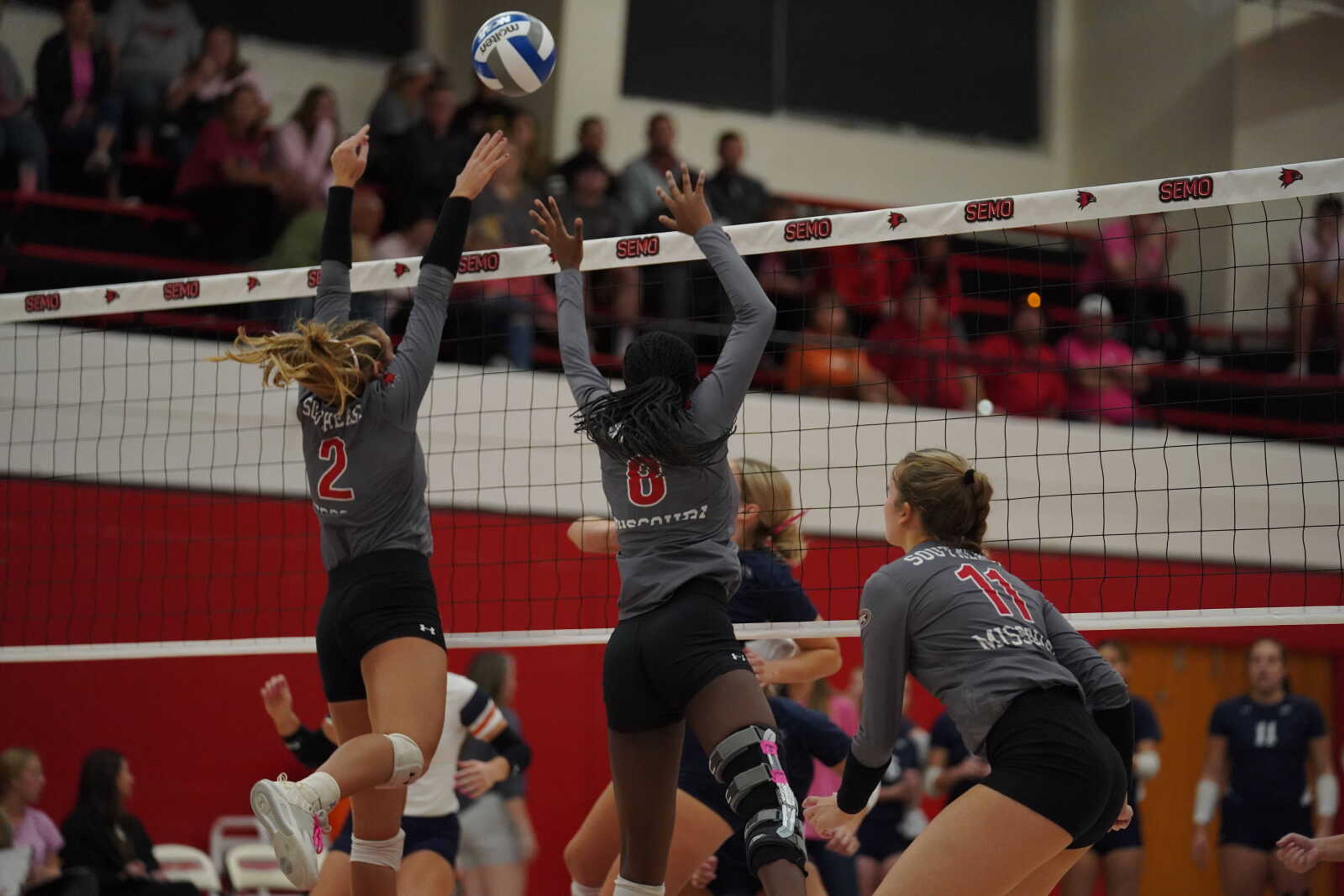 SEMO freshman outside hitter Lucy Arndt (2) and graduate student middle blocker Talia Gouard (8) go up for a block, while redshirt senior rightside hitter Kaelyn O’Brien watches against UT-Martin on October 6th at Houck Field House.  The Redhawks would win the match in three straight sets.