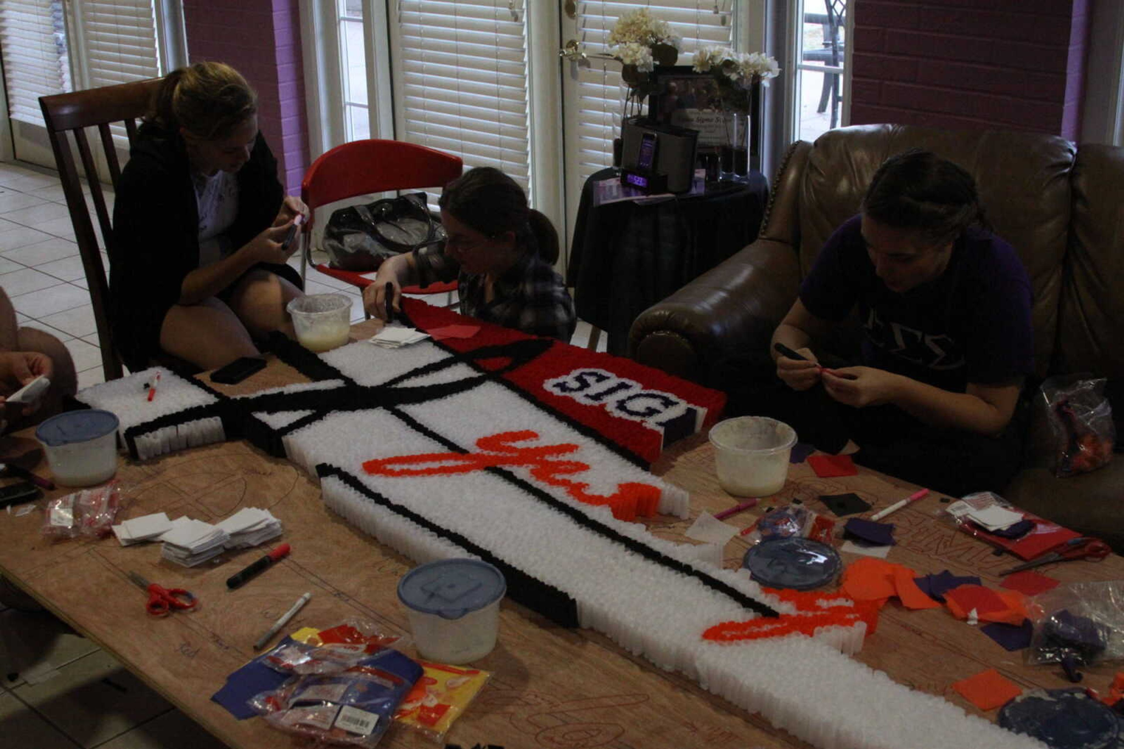 Alpha Kappa Psi and Sigma Sigma Sigma prepare their homecoming float.  - Photo by Kelso Hope