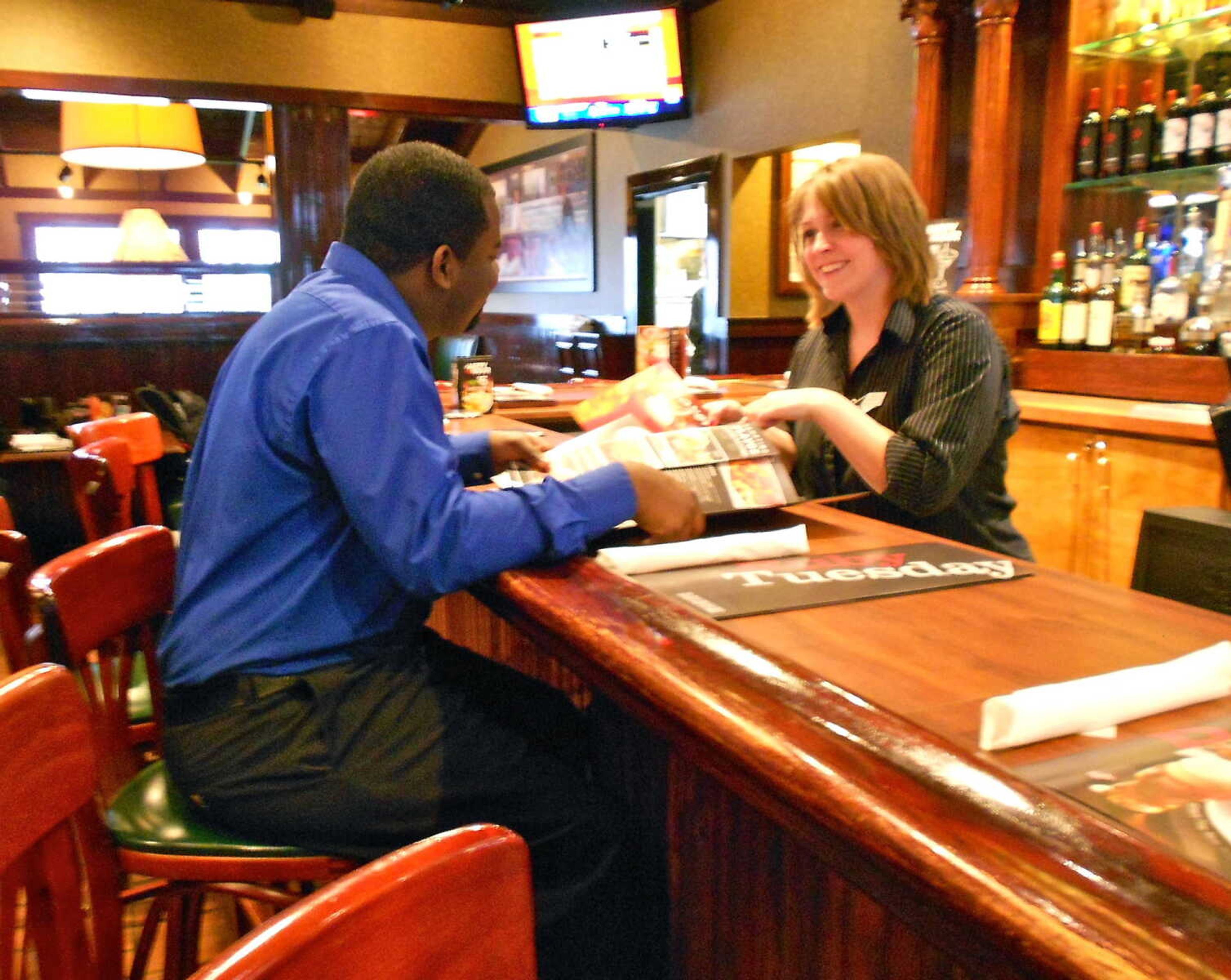 Shawna Shweain greeting a guest and suggesting menu items during her serving shift at Ruby Tuesdays. Photo by Hannah Parent