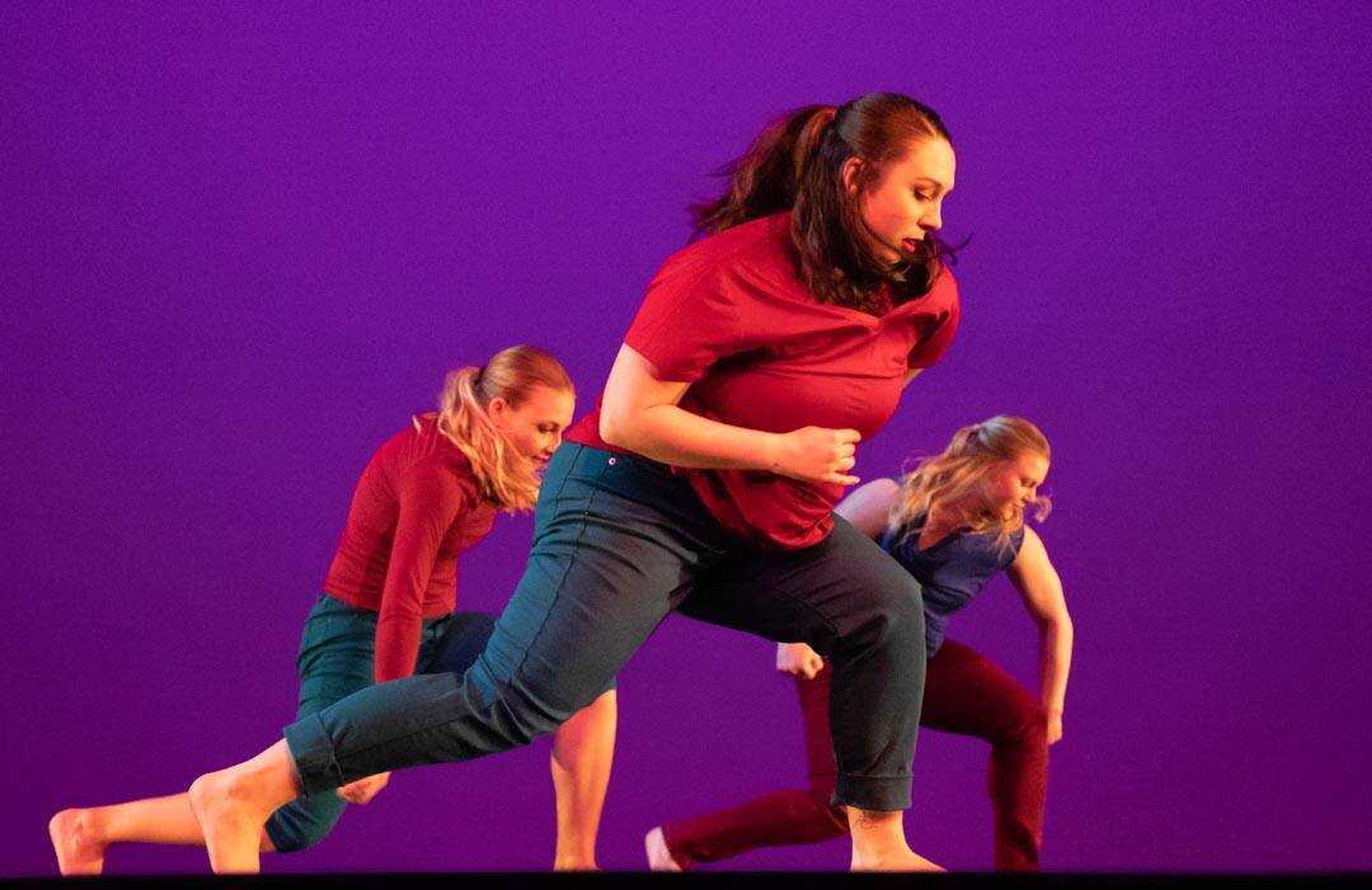 Senior Kaetlin Lamberson (left), junior Lizzie Madden (center) and junior Chloe Galovich perform in unison in "You Go, I Go," choreographed by guest artist Autumn Eckman, during a Spring into Dance dress rehearsal.