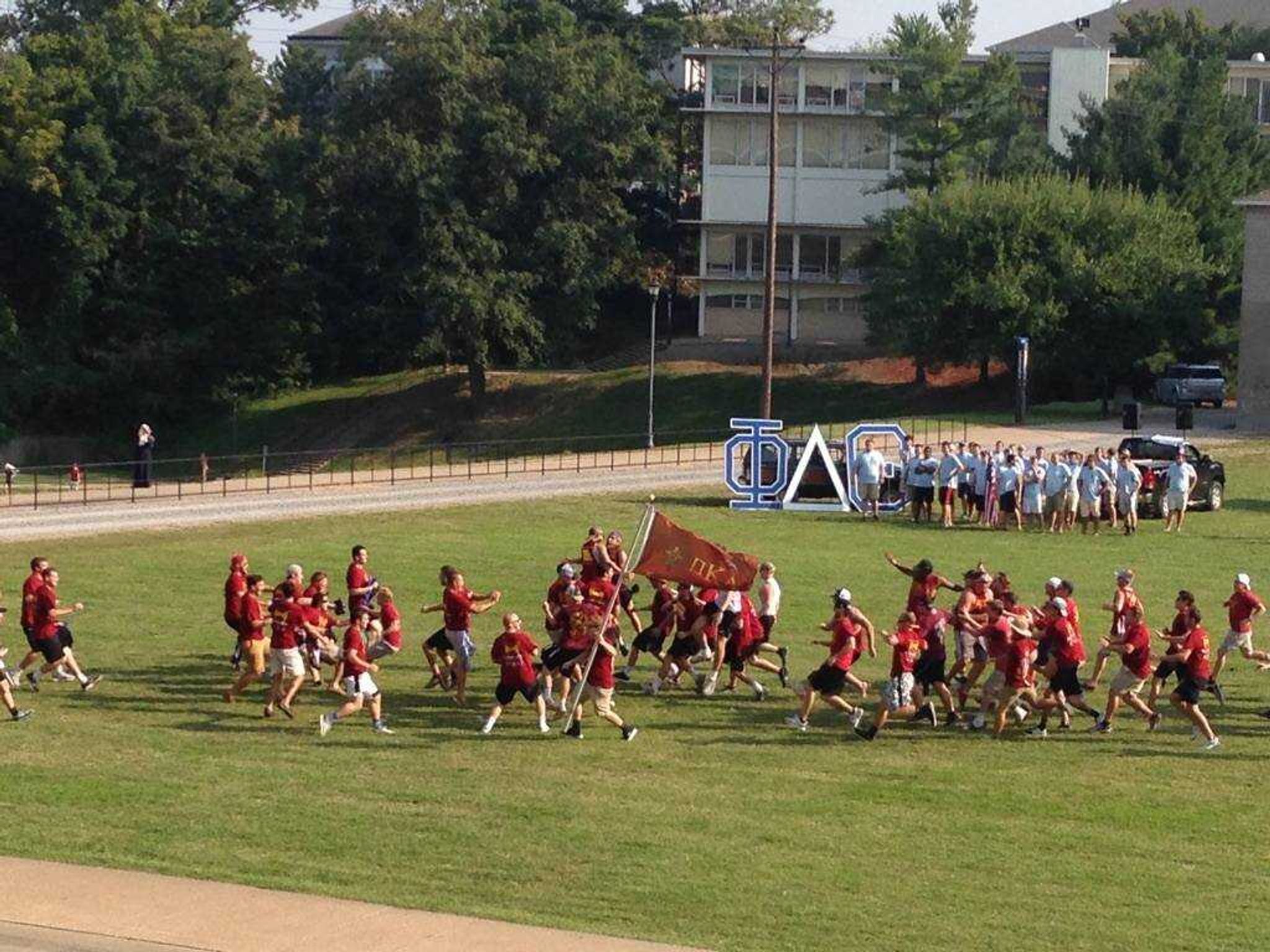 The new members of Pi Kappa Alpha running to the active members on bid day.