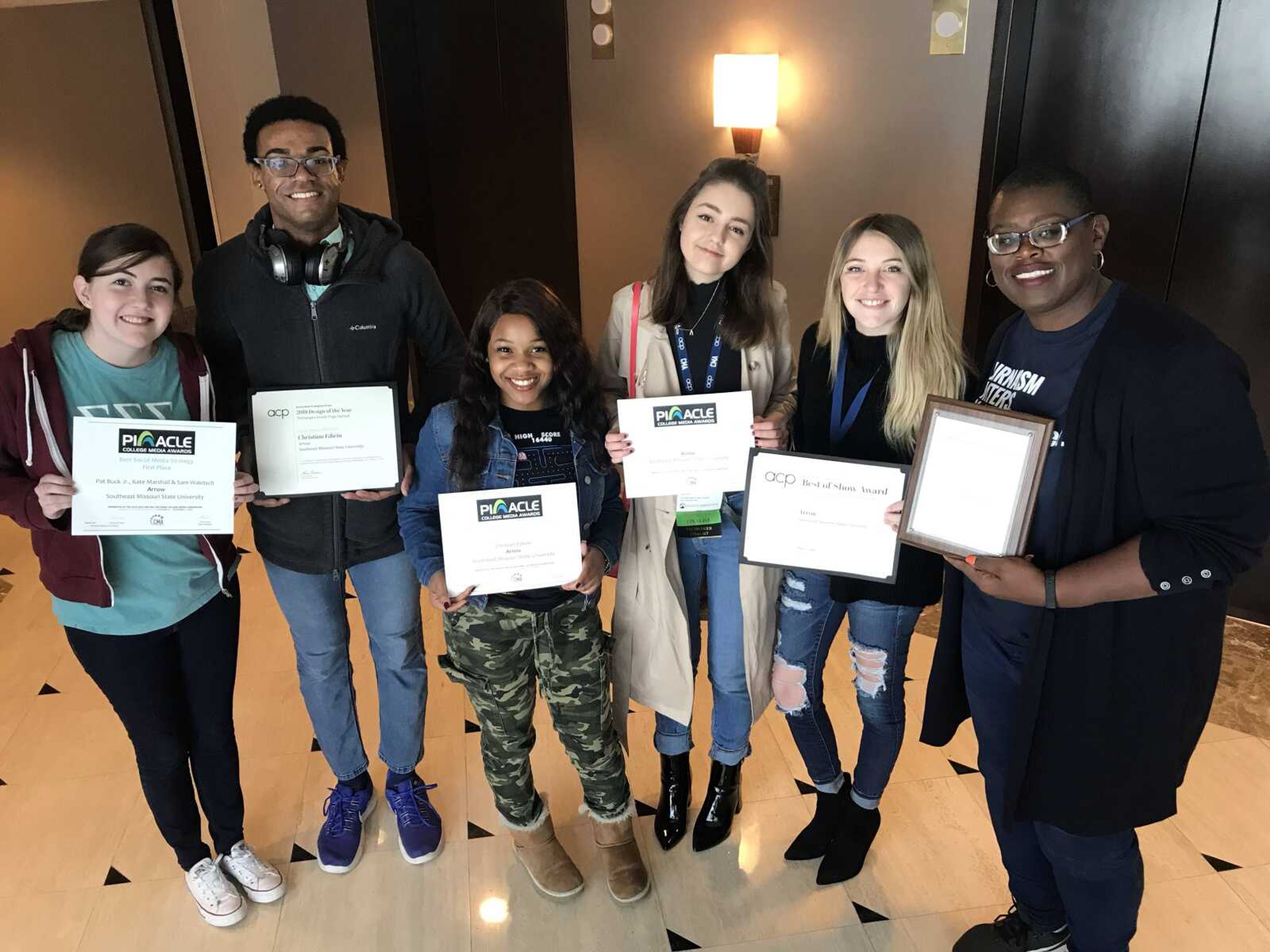 Madison Stuerman (left), Jelani Days, Karis Gamble, Nicolette Baker, Brooke Holford and Tamara Zellars Buck pose with the six awards the Arrow won at the Fall National College Media Convention in Washington D.C. 