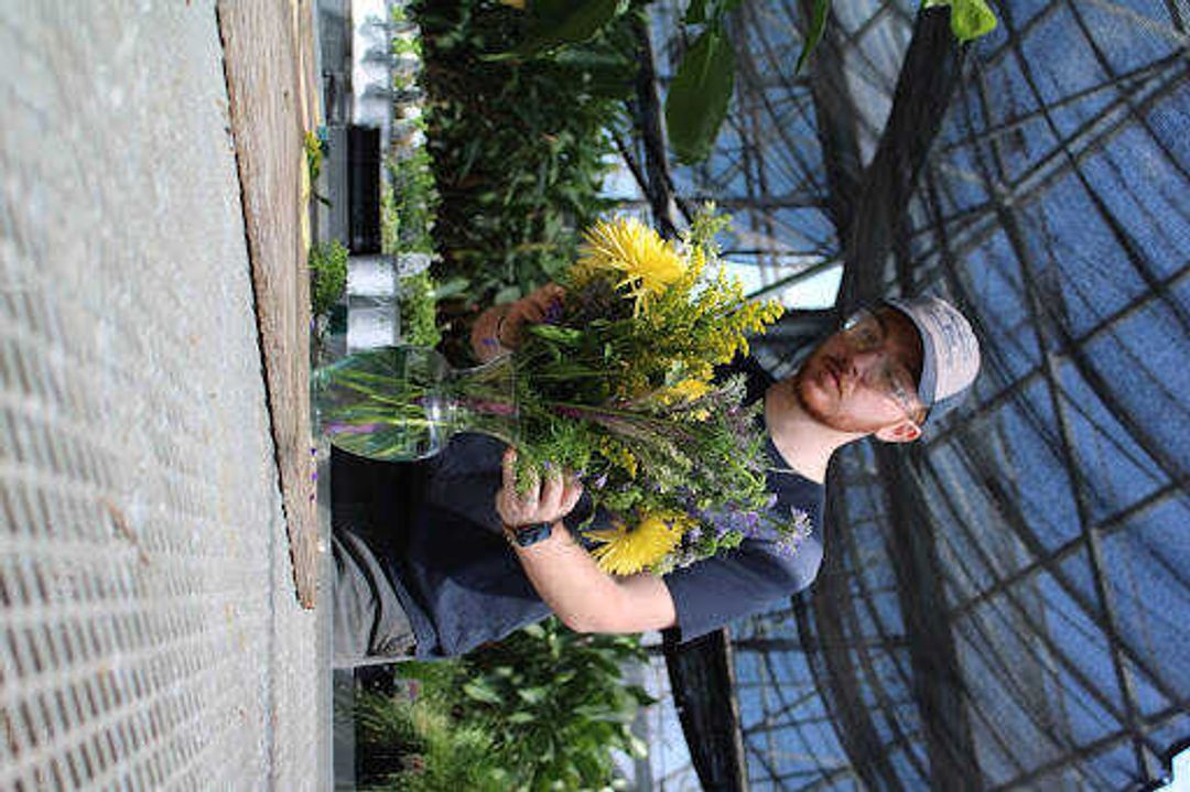 Ian Graves designs a simple arrangement
at the Charles Hutson Horticulture Greenhouse. He says he loves
creating different styles.
