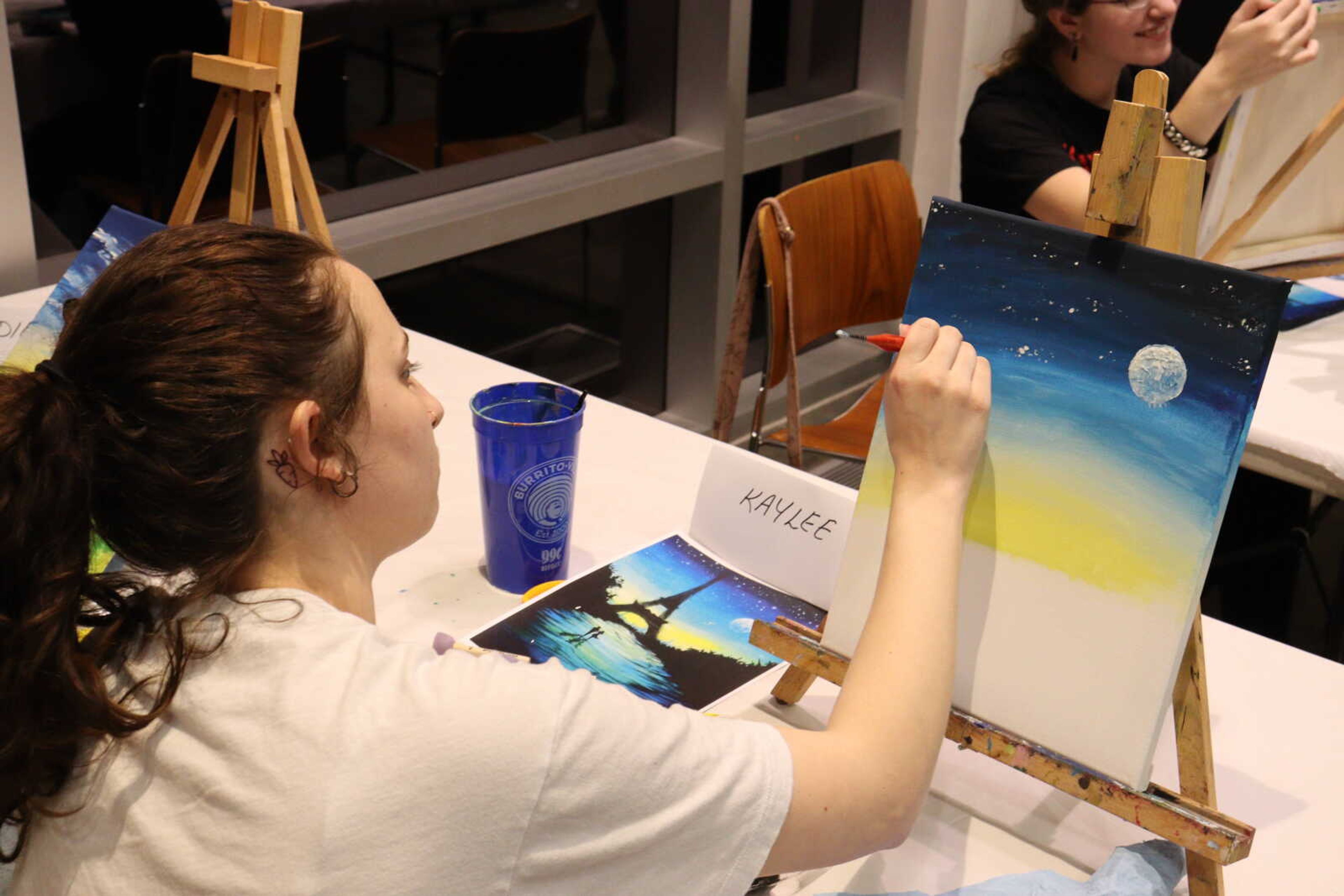 Freshman double major of psychology and art Kaylee Shelby adds stars to her Paris night sky. 
