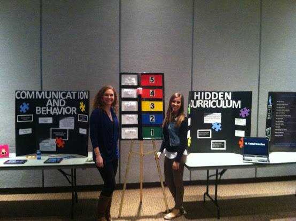 Jamie Norrenberns (left) and Sarah Derkos (right) represent Assist with Autism at a student fair. Submitted Photo
