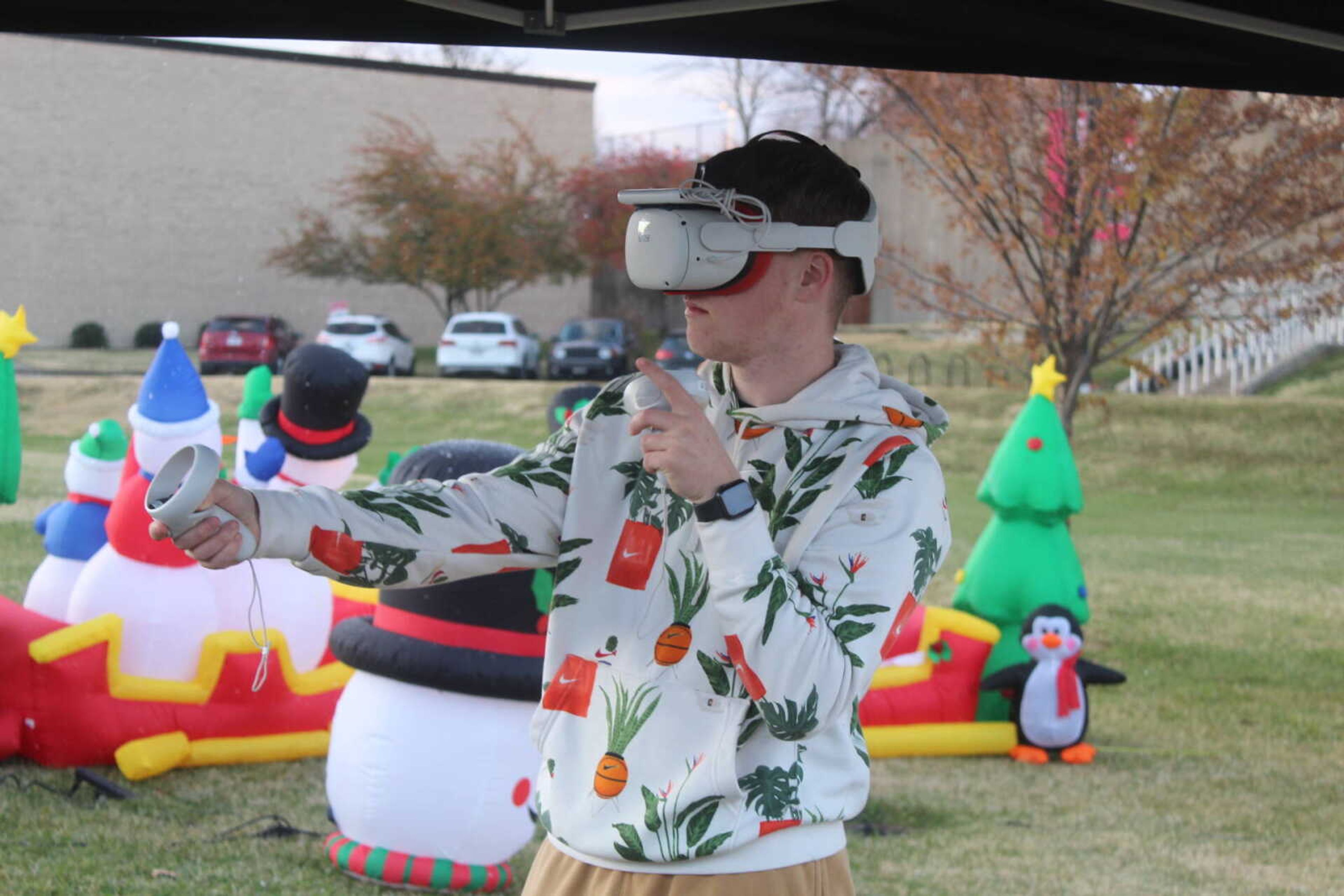 A SEMO student uses a VR headset to participate in a virtual reality snowball fight at Winterfest.