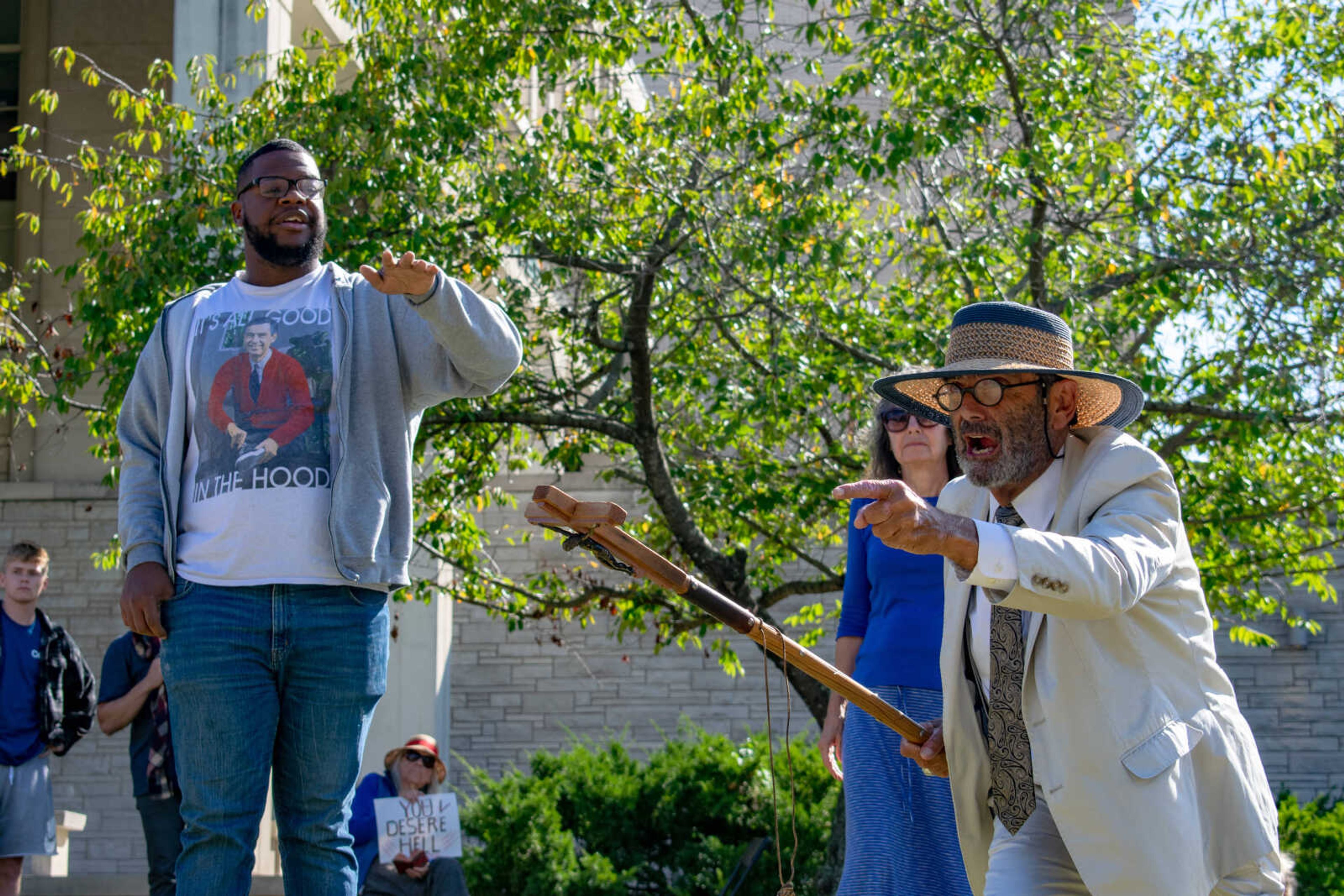 Southeast student Noah Coates (left) attempts to reason with Brother Jed (right) while Jed points fingers into the crowd in front of Kent Library on Wednesday, Oct. 9.