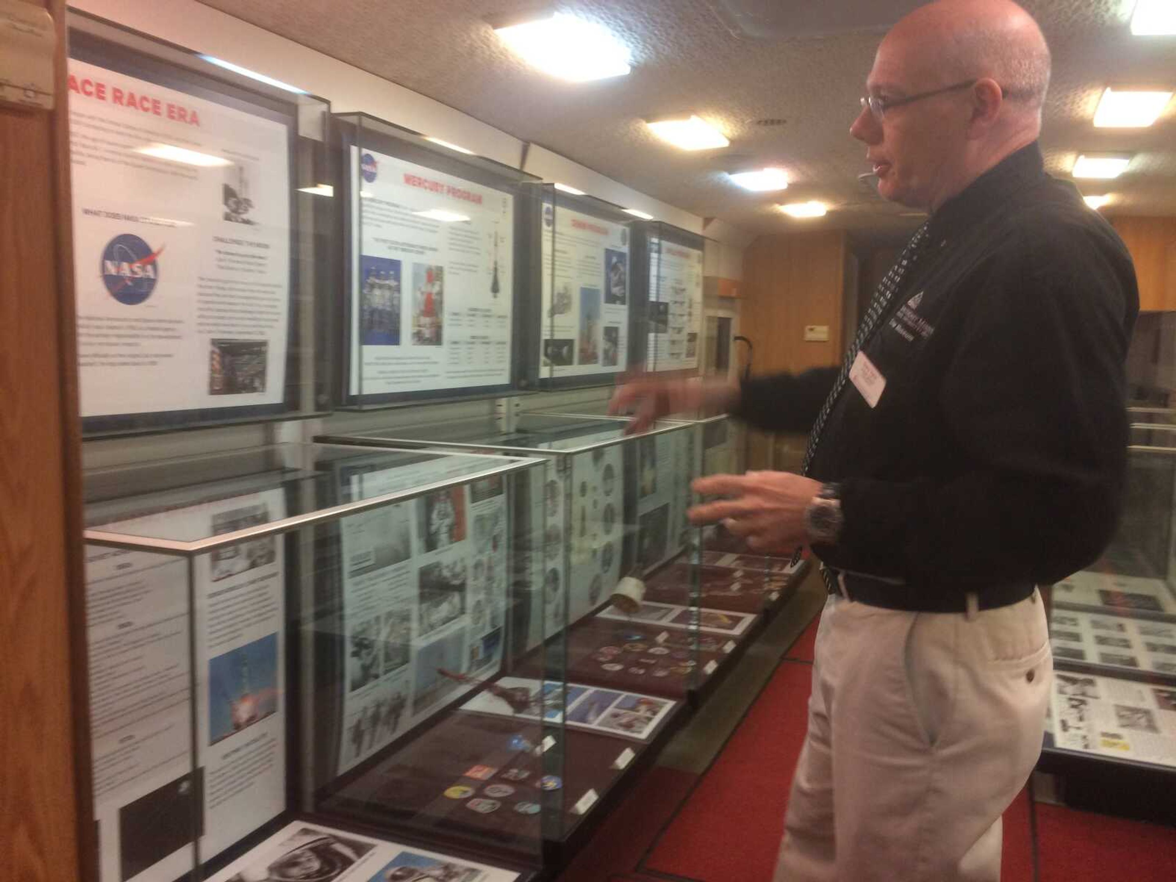 Gary Tyler describing contents of showcases in the Southeast Explorer Mobile Museum to audience members