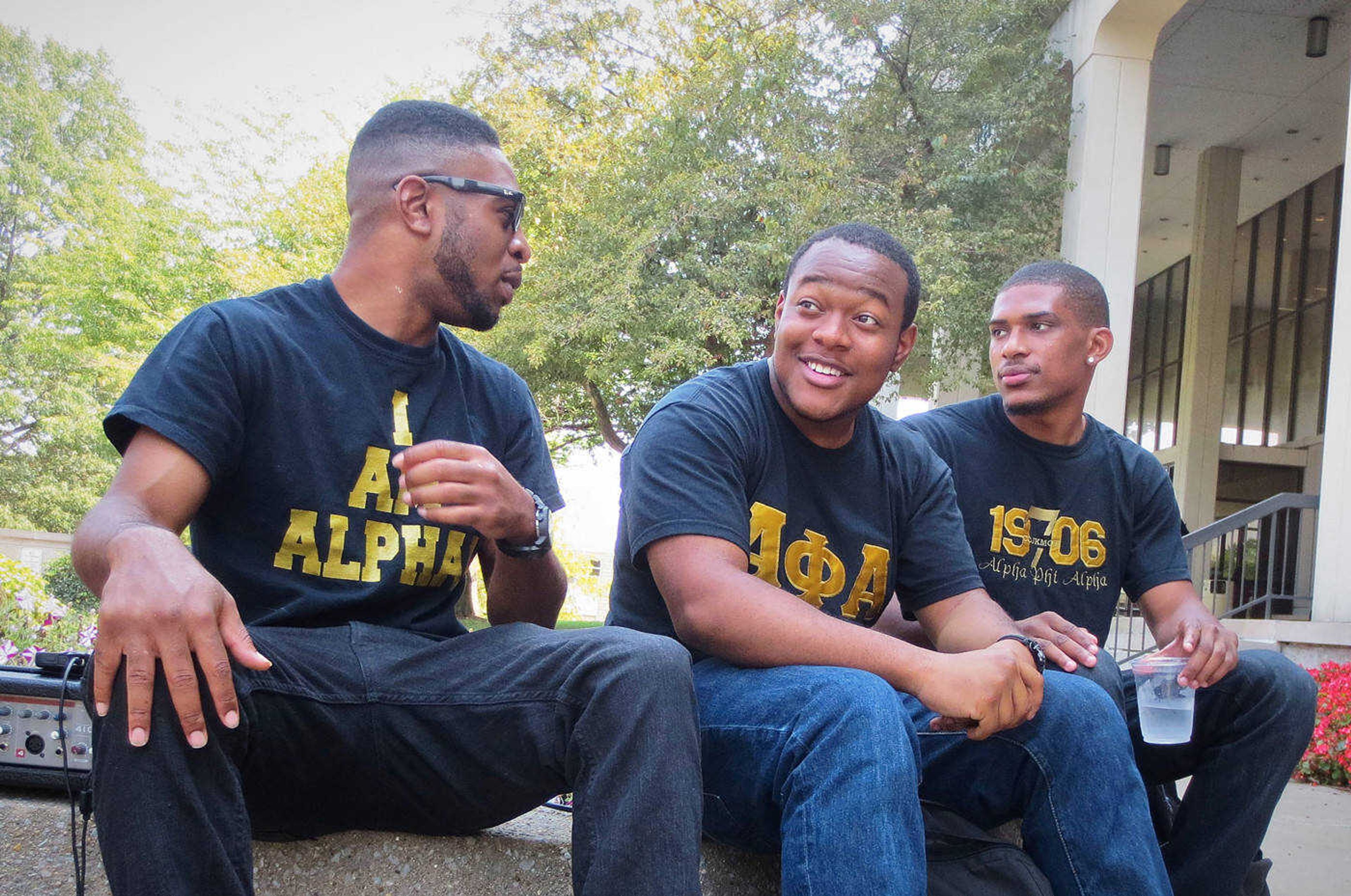  Alpha Phi Alpha members Joe Hill, Martez Byrth and Jeremiah Hathore hang out and listen to music.  Photo by Kirsten Trambley