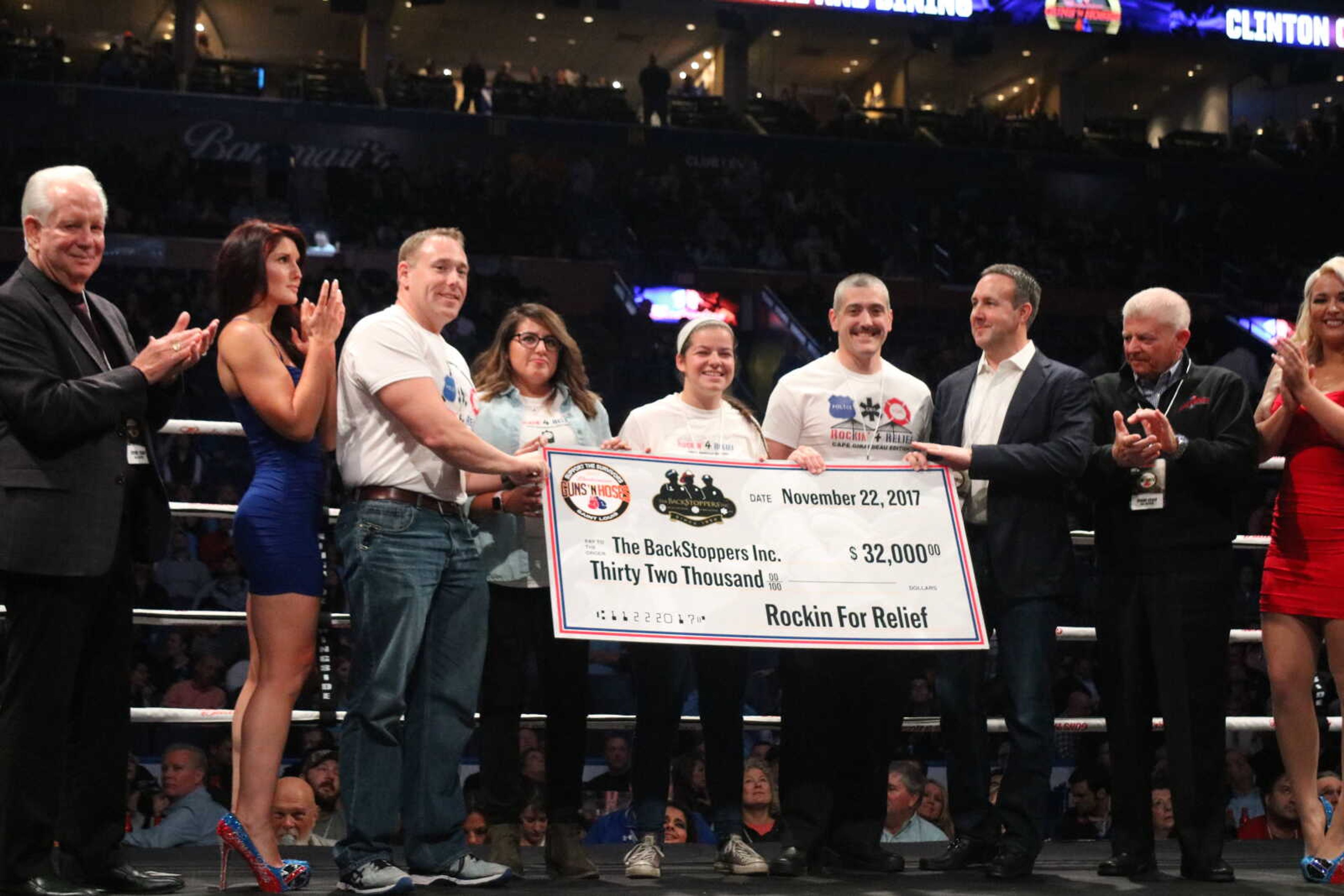 Jennifer Rubin (center) donates $32,000 to BackStoppers at St. Louis Guns ‘N Hoses in Nov. 2017. The money donated was money raised from Rockin’ 4 Relief events.