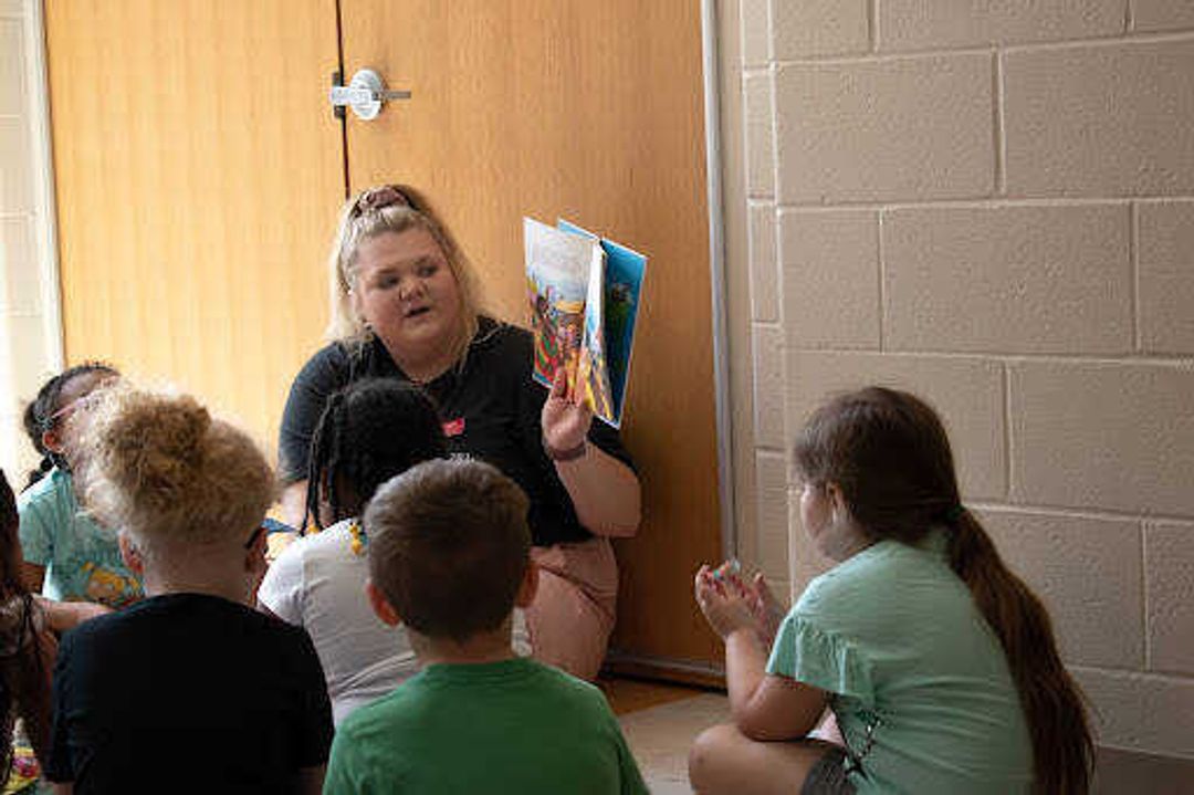 Early Elementary Education Major and SMSTA PR Exec Jordan Merli reads to students after completing the literacy walk. Students ate candy and listened to Merli's story telling. 