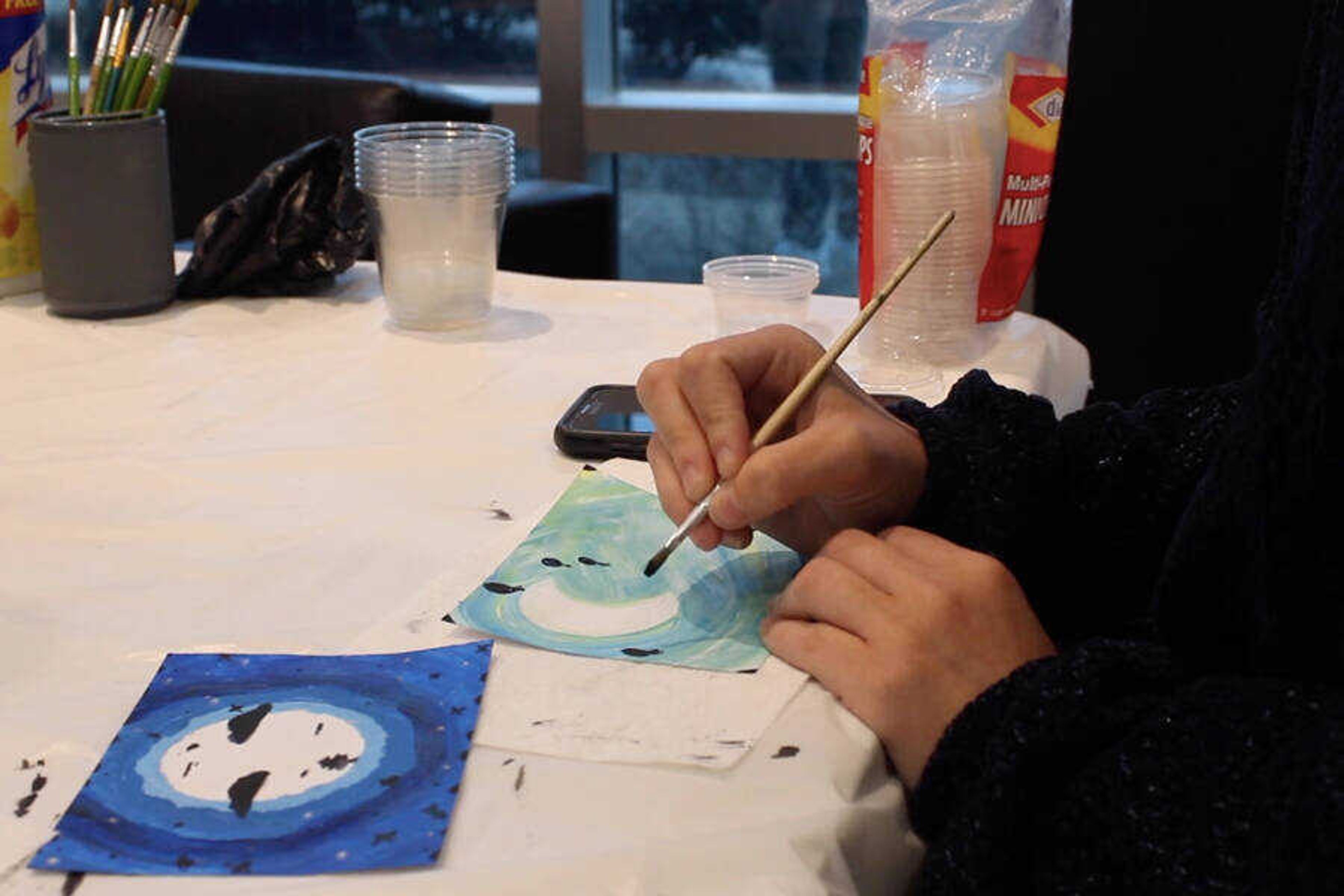 An attendee at the Crisp Museum Heritage Day participates in the moon painting activity.

