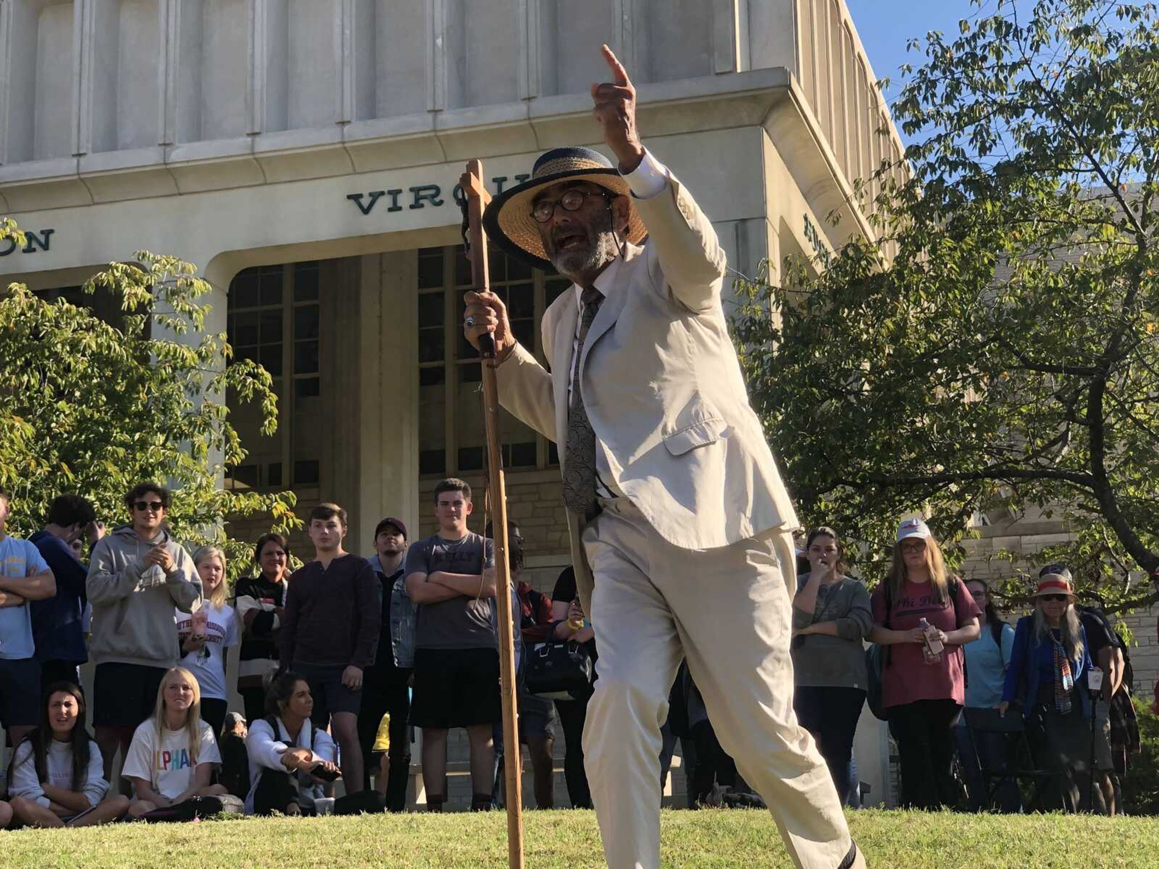 Brother Jed holds a crucifix staff and points into the crowd in front of Kent Library on Wednesday, Oct. 9.