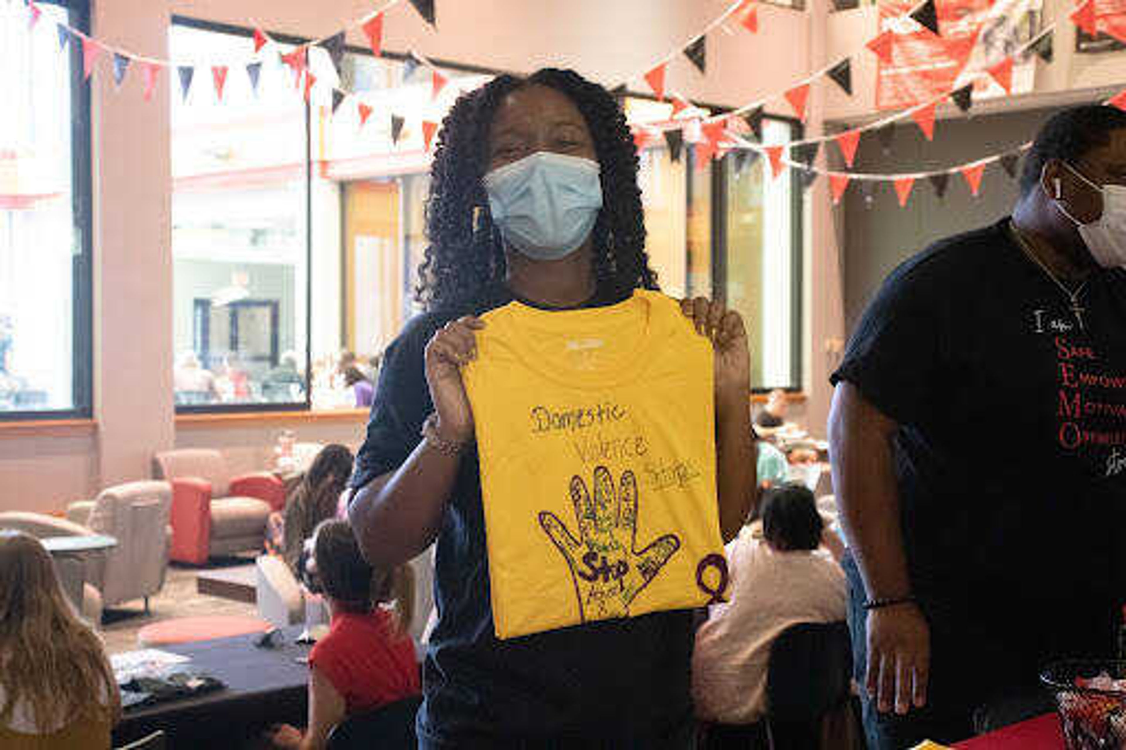 Shannon Washington, graduate assistant for Campus Violence Prevention, poses for a photo at the Health and Wellness Fair. Many different t-shirts were available for students, including those reading “I am SEMO Strong” and “Let’s Talk SEMO”. 