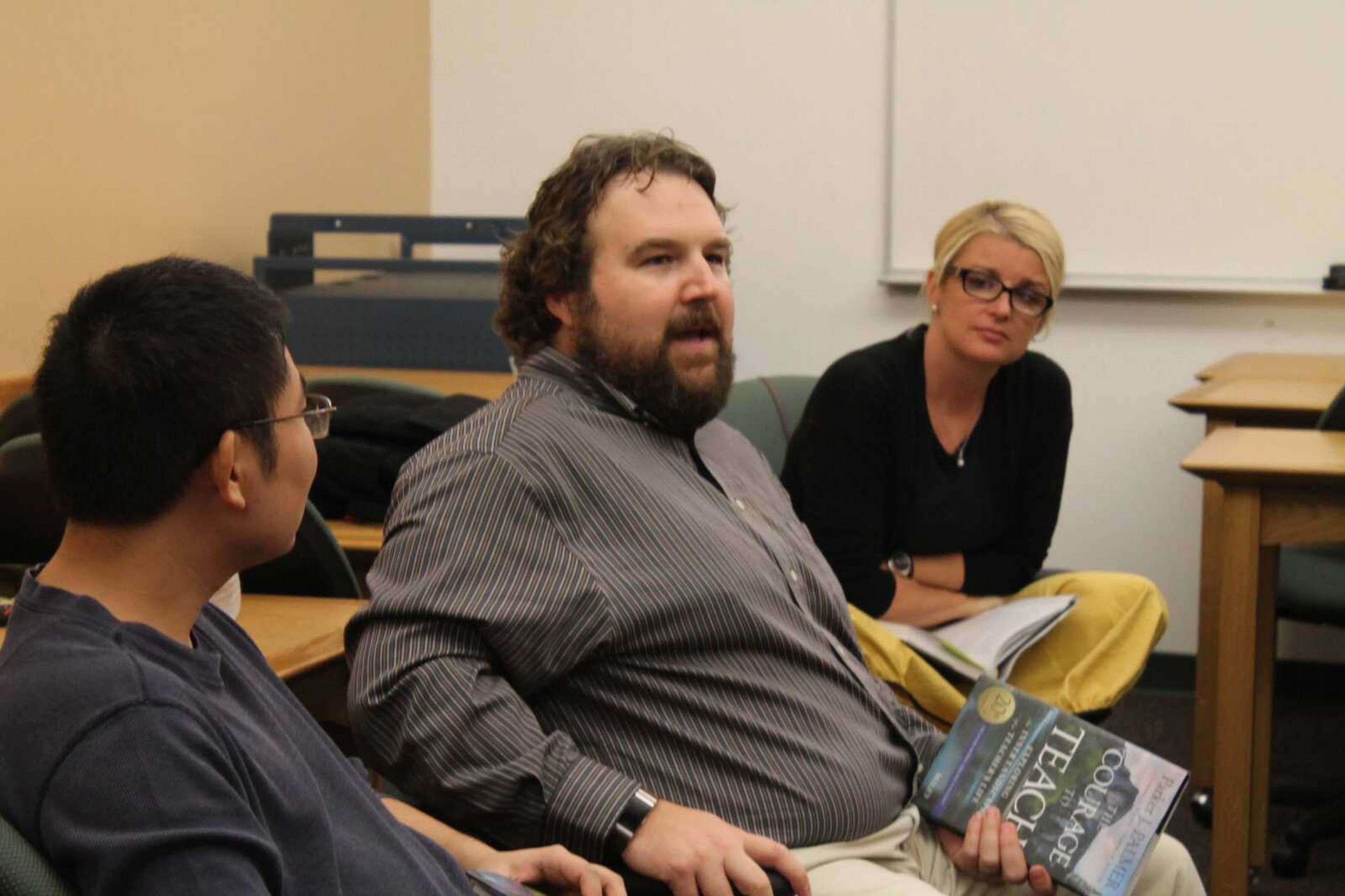 Nick Johnson, an associate professor in the department of management, tells a story about balancing his personal life and teaching in faculty book study in the library Sept. 26