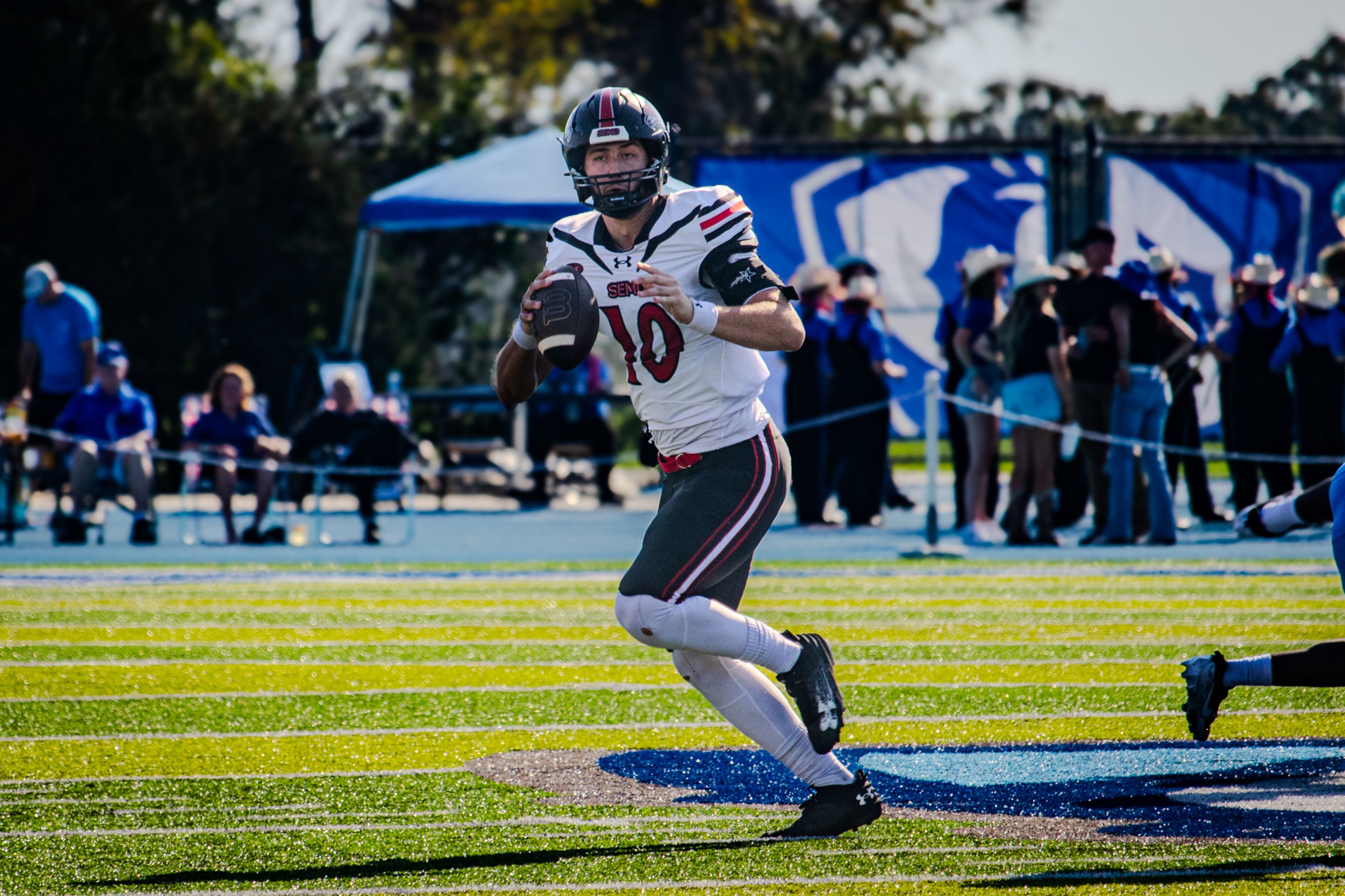 Senior quarterback Paxton DeLaurent scrambles to make a pass against EIU.