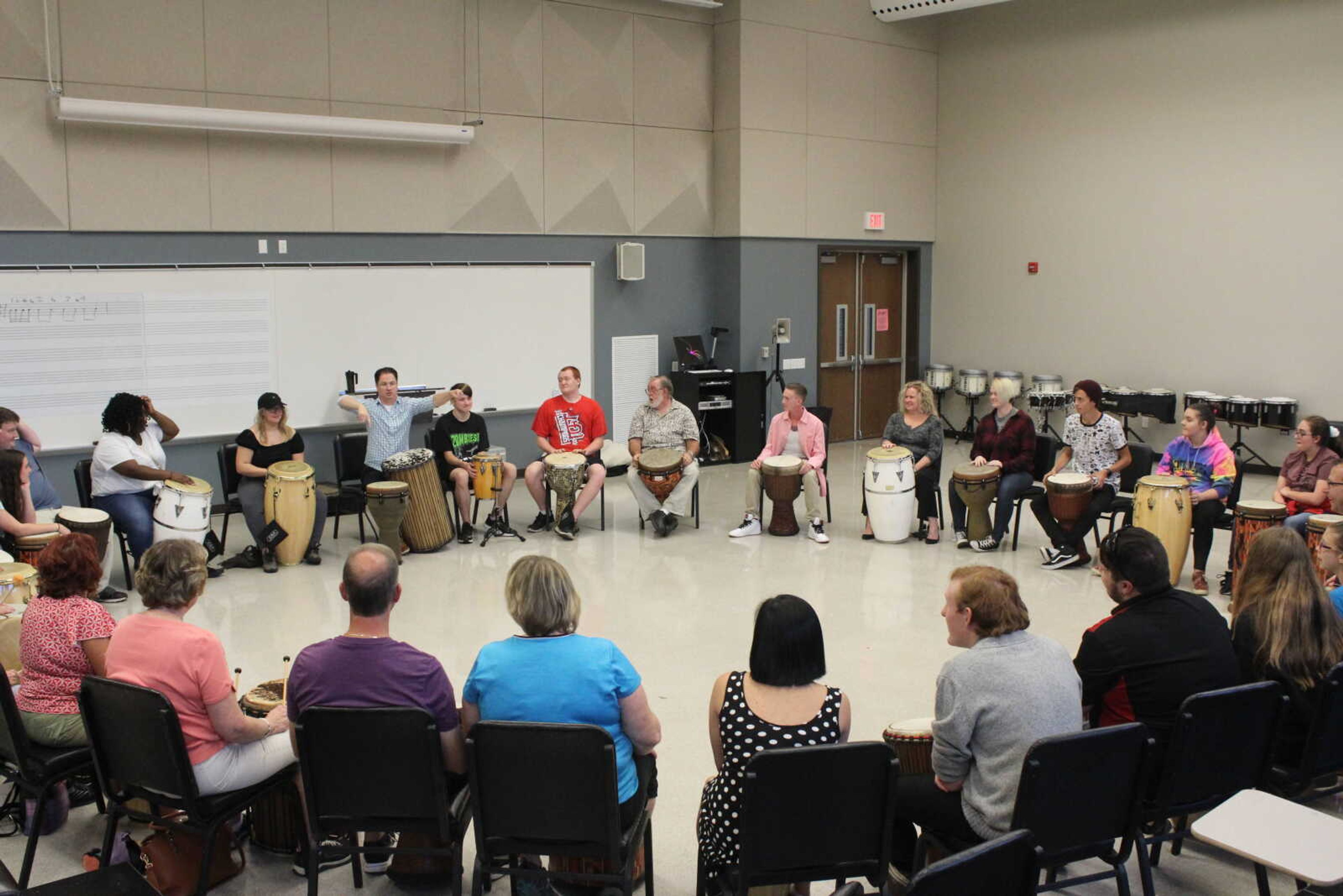Southeast director of percussion Shane Mizicko (center) leads the Drum Circle event on Sept. 11.