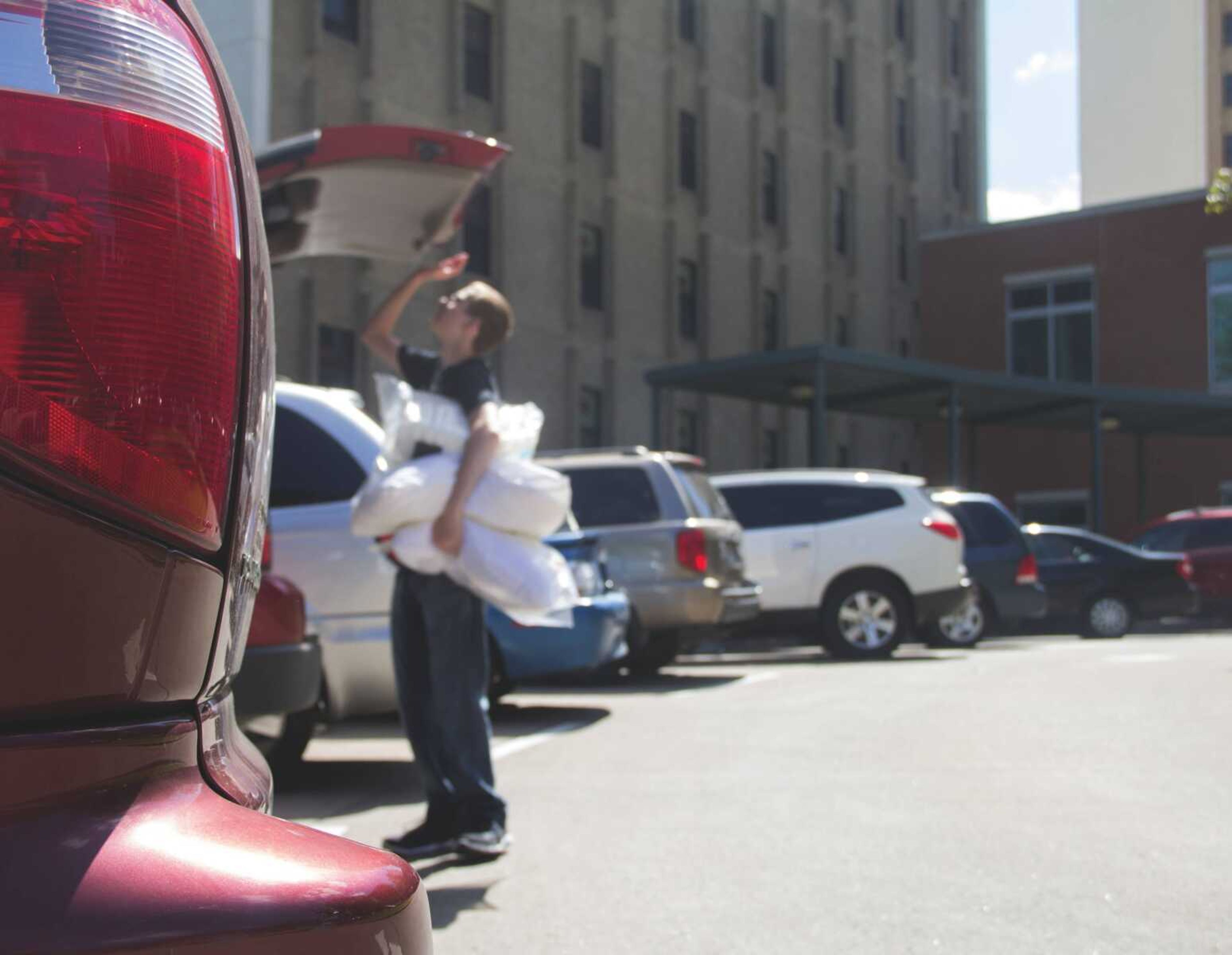 A Southeast student unloads the trunk of a car on move-in day, Aug. 20, in Towers Circle.