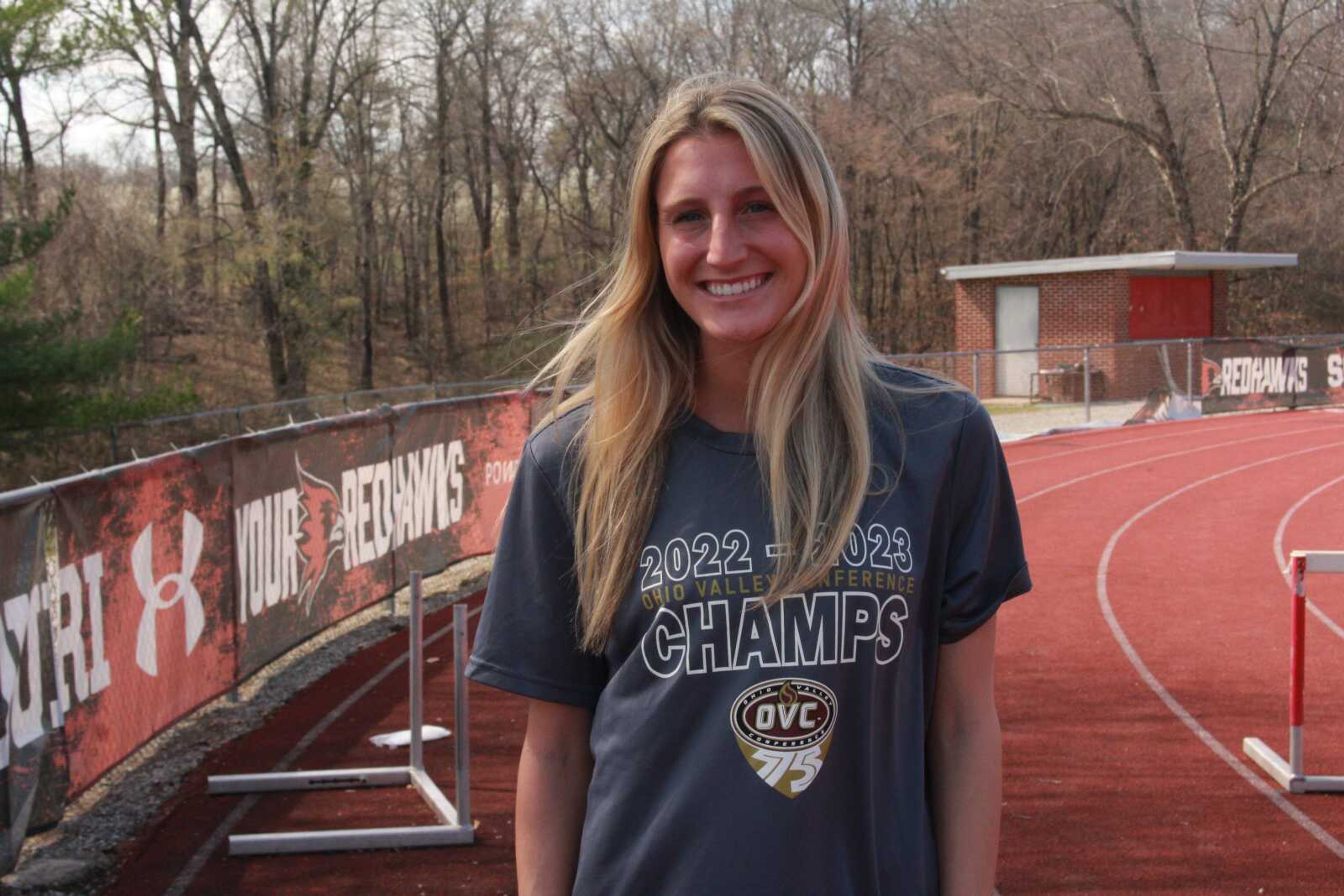 Sophomore distance runner Taylor Fox poses for a photo wearing her 2023 OVC Conference Championship shirt at the Abe Stuber Track Complex.