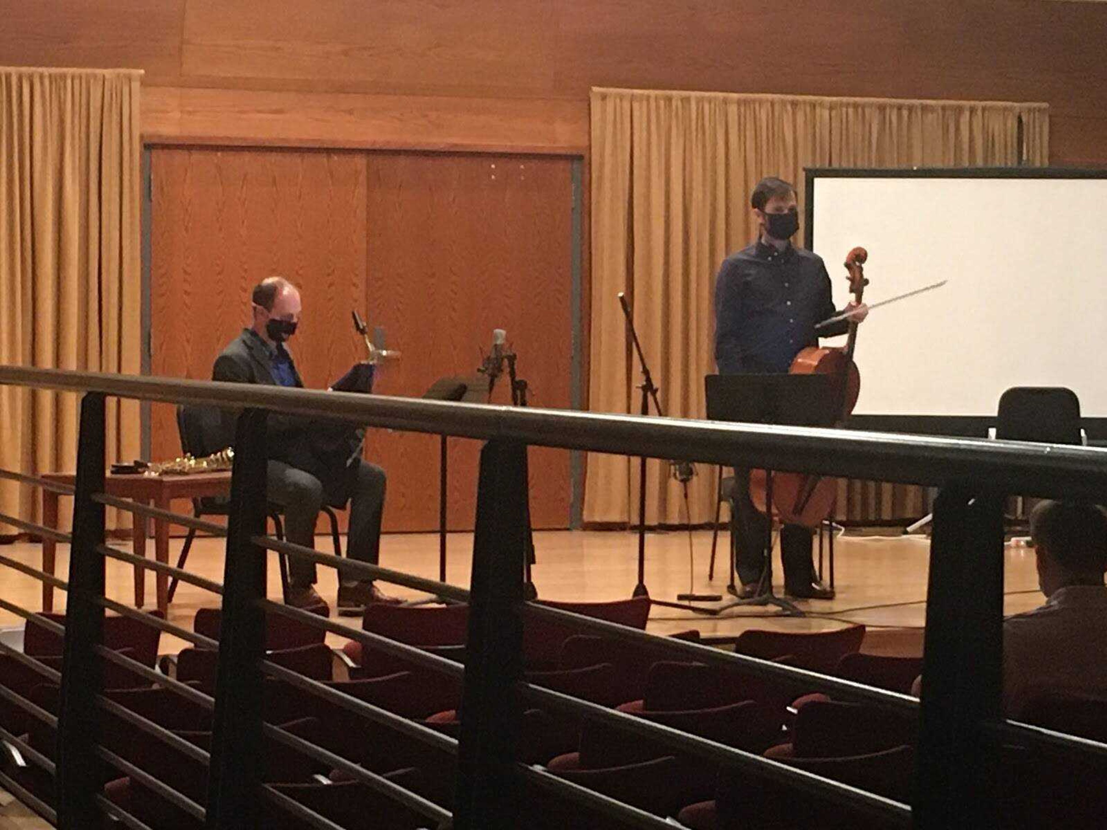 Daniel Ketter (right), one-half of the new cello and saxophone duo Cellax, addresses the crowd after playing their first piece, “Suite Off Pist” by Svante Henryson. Ketter and Zach Stern (left) performed together publicly for the first time Nov. 16 at the River Campus.
