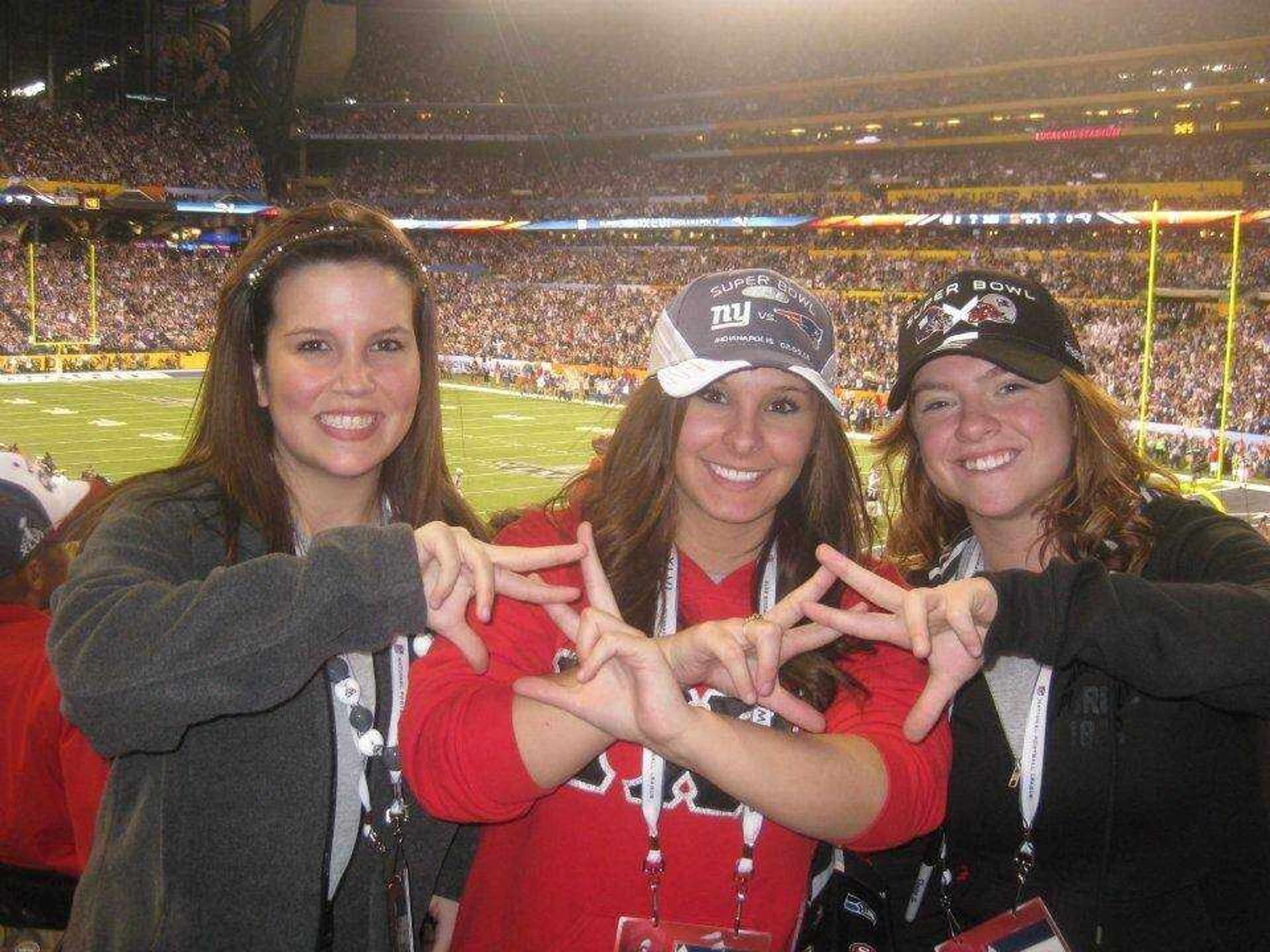 from left to right: Alpha Chi Omega sorority members Myka Fitch, Chelsea Chockley, and Kelly Farrell at the Super Bowl Game