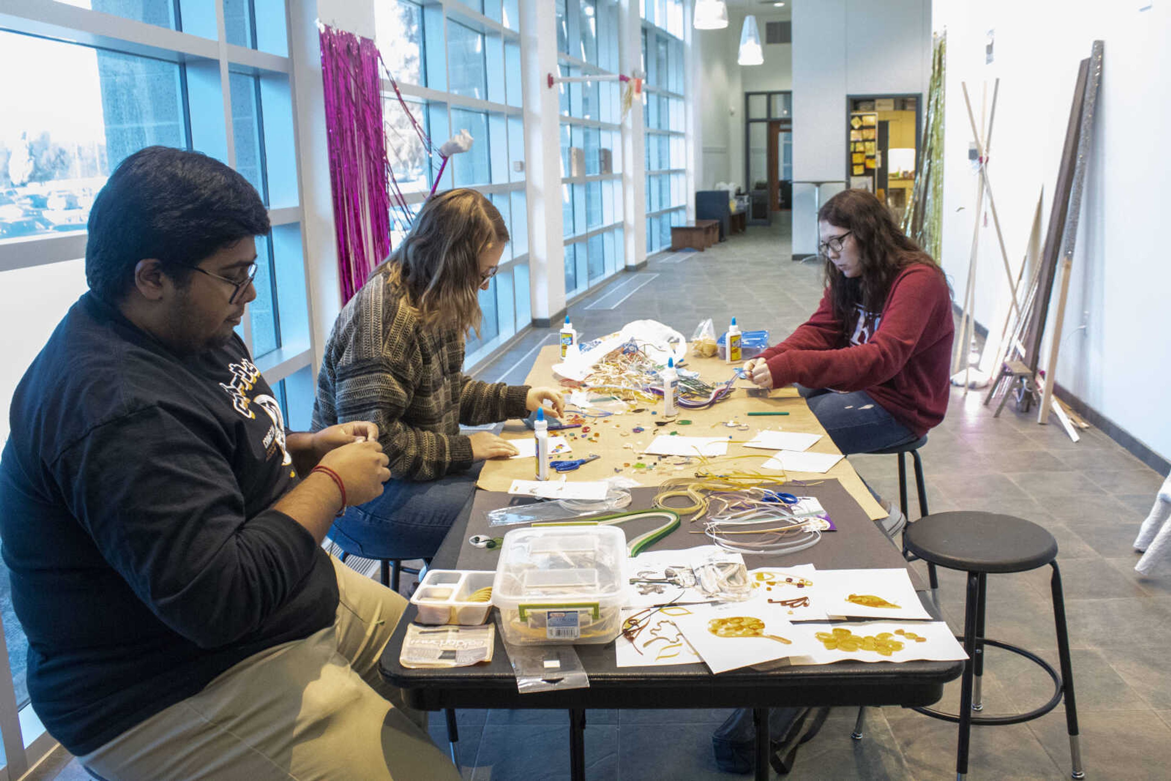 Southeast students Rahul Nair, Emily Reese, and Jordan Stonehouse work on crafts at the Crisp Museum Folktale Day on Nov. 7