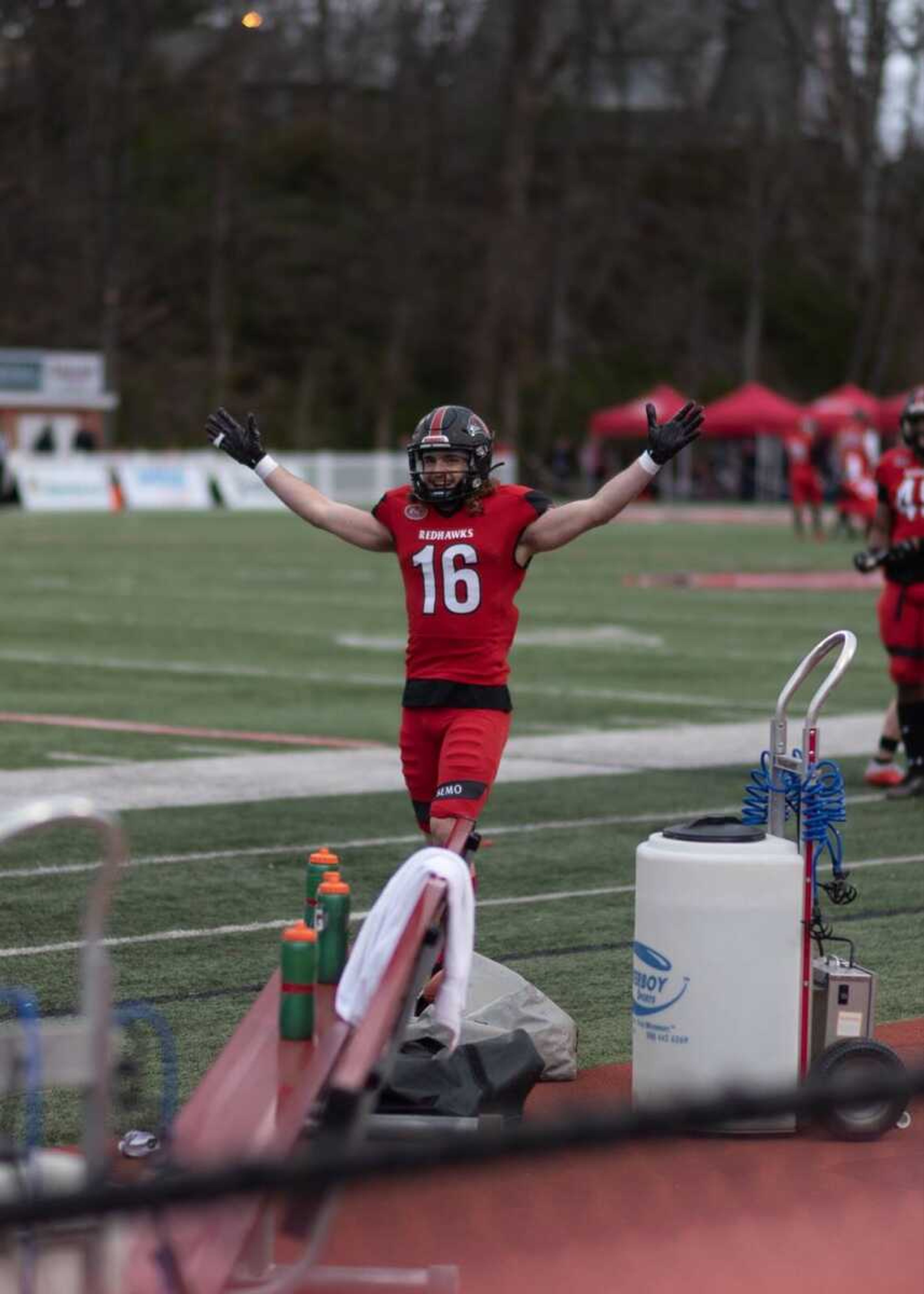 Colby Cornett (left) celebrates on the sideline after scoring a touchdown vs Austin Peay at Houck Field on March 14.