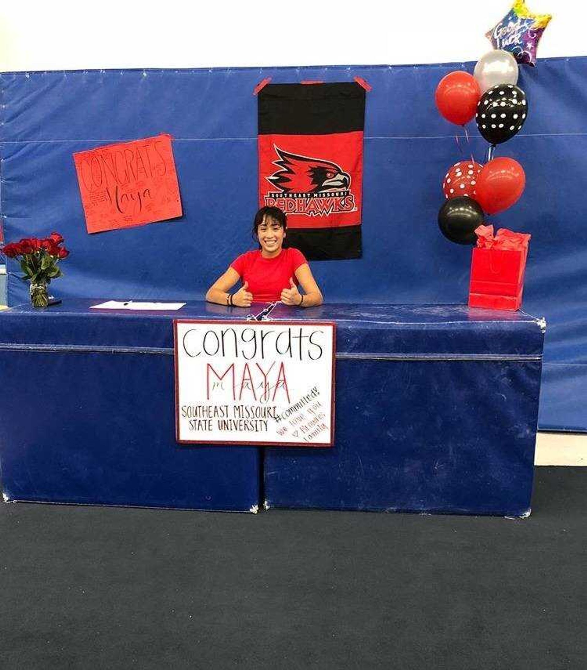 Freshman Maya Tren signing papers at her high school to commit to Southeast.