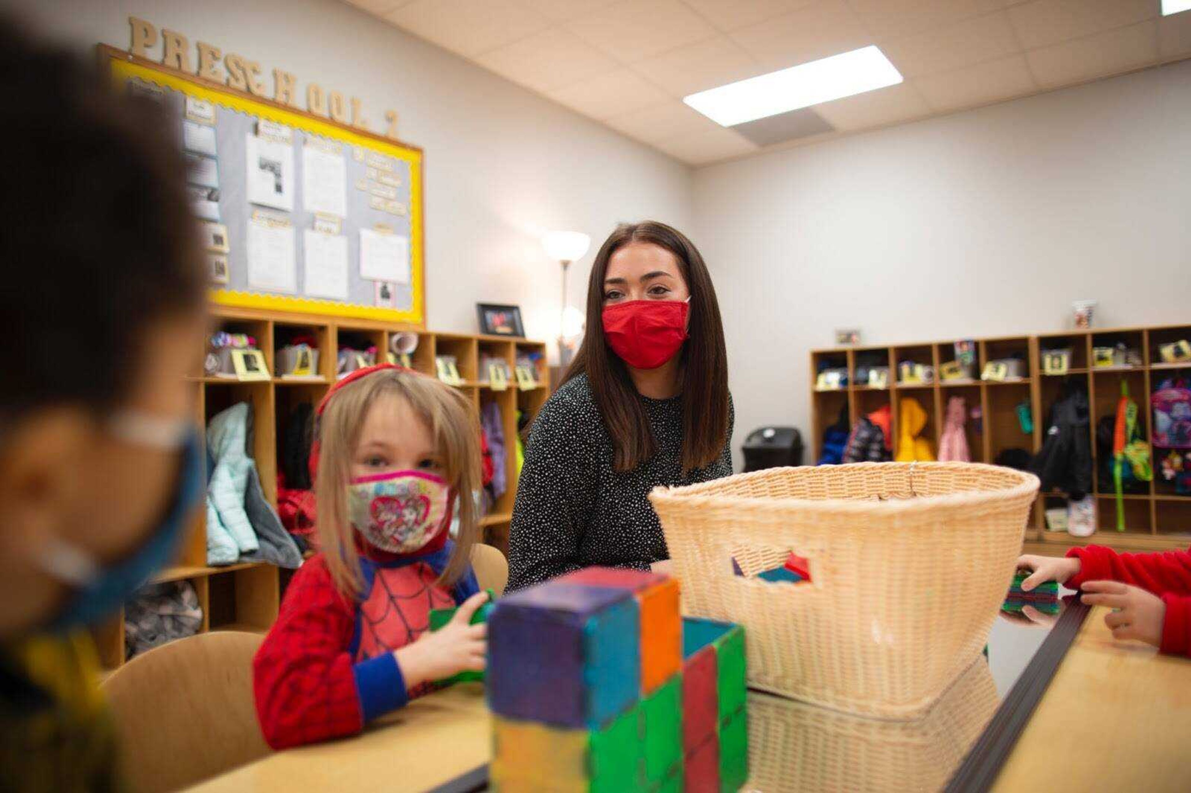 University students and preschoolers play with blocks at the University School for Young Children.