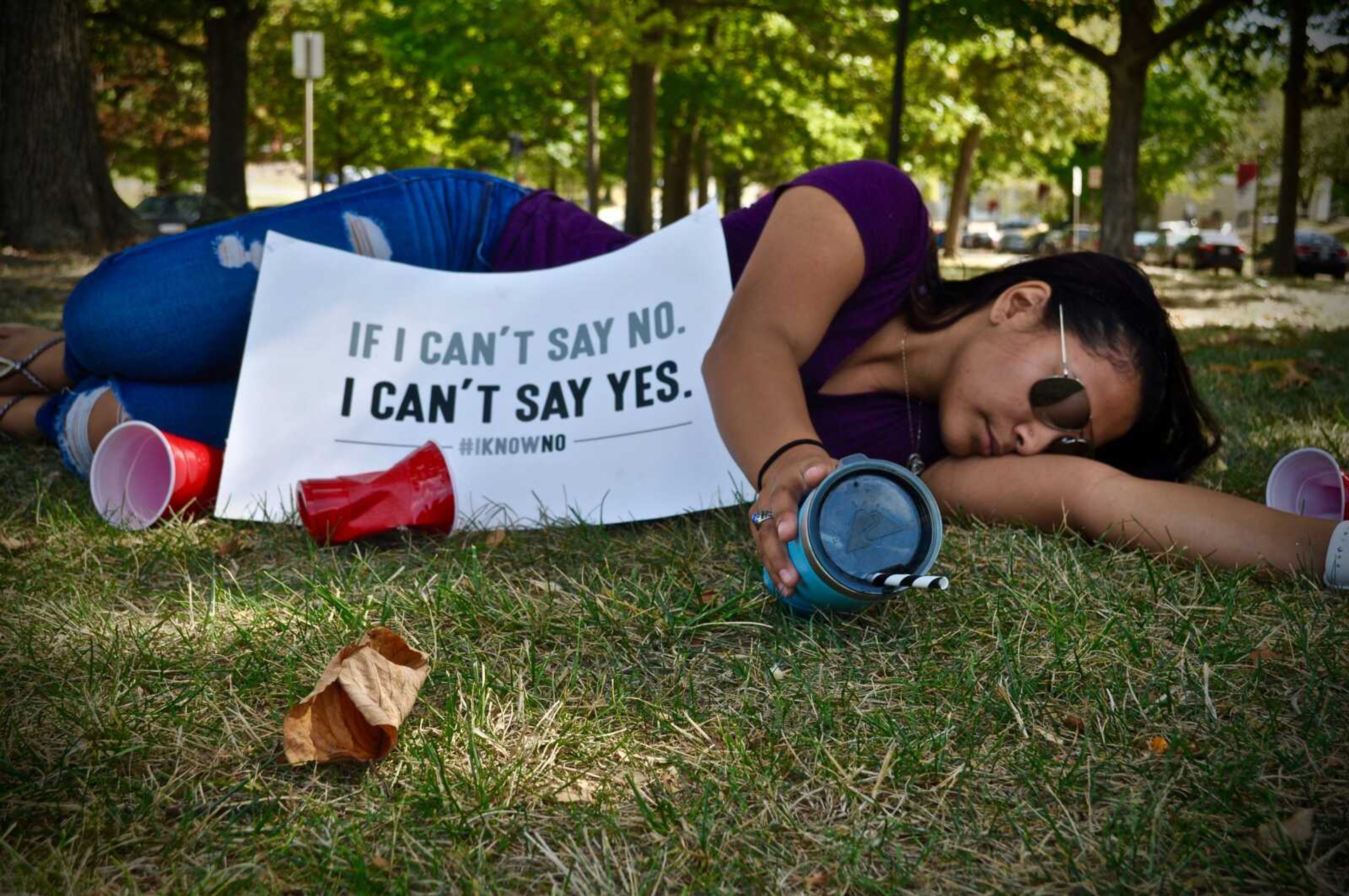 Maria Bolf lays down to protest to raise awareness of sexual and domestic violence outside of Kent Library on Oct. 4.