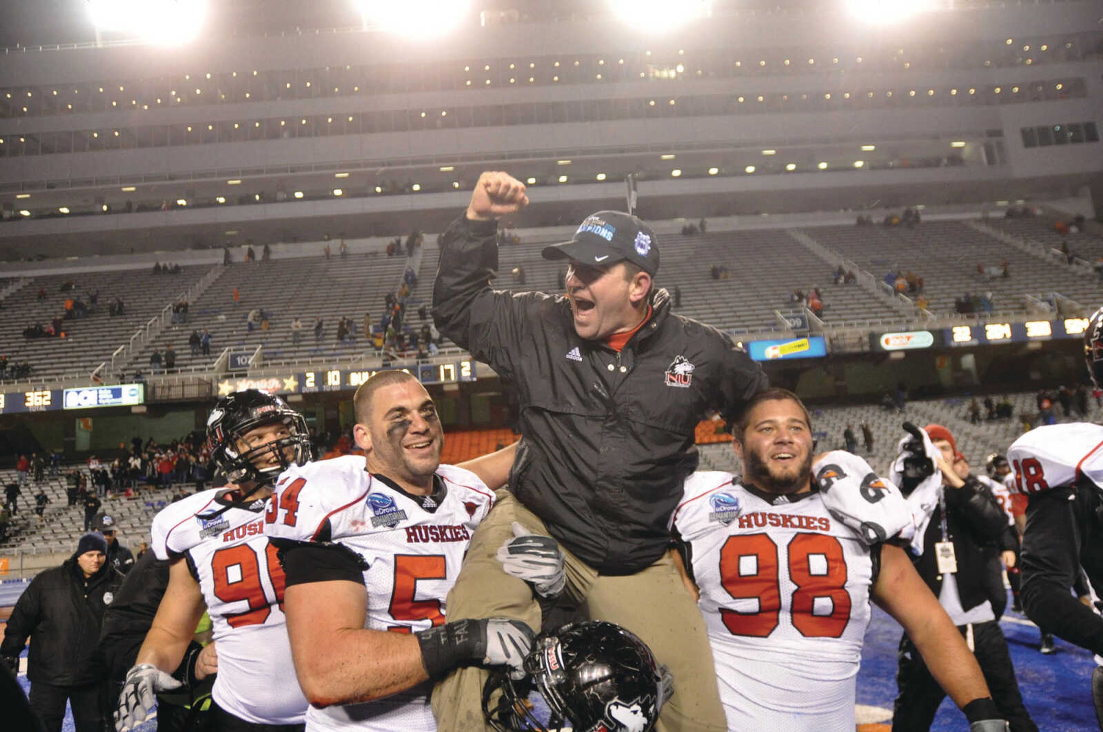 NIU Husky players lift up Tom Matukewicz after their win at the Humanitarian Bowl in 2010. Photo by Charlie Litchfield courtesy of Idaho Press Tribune.