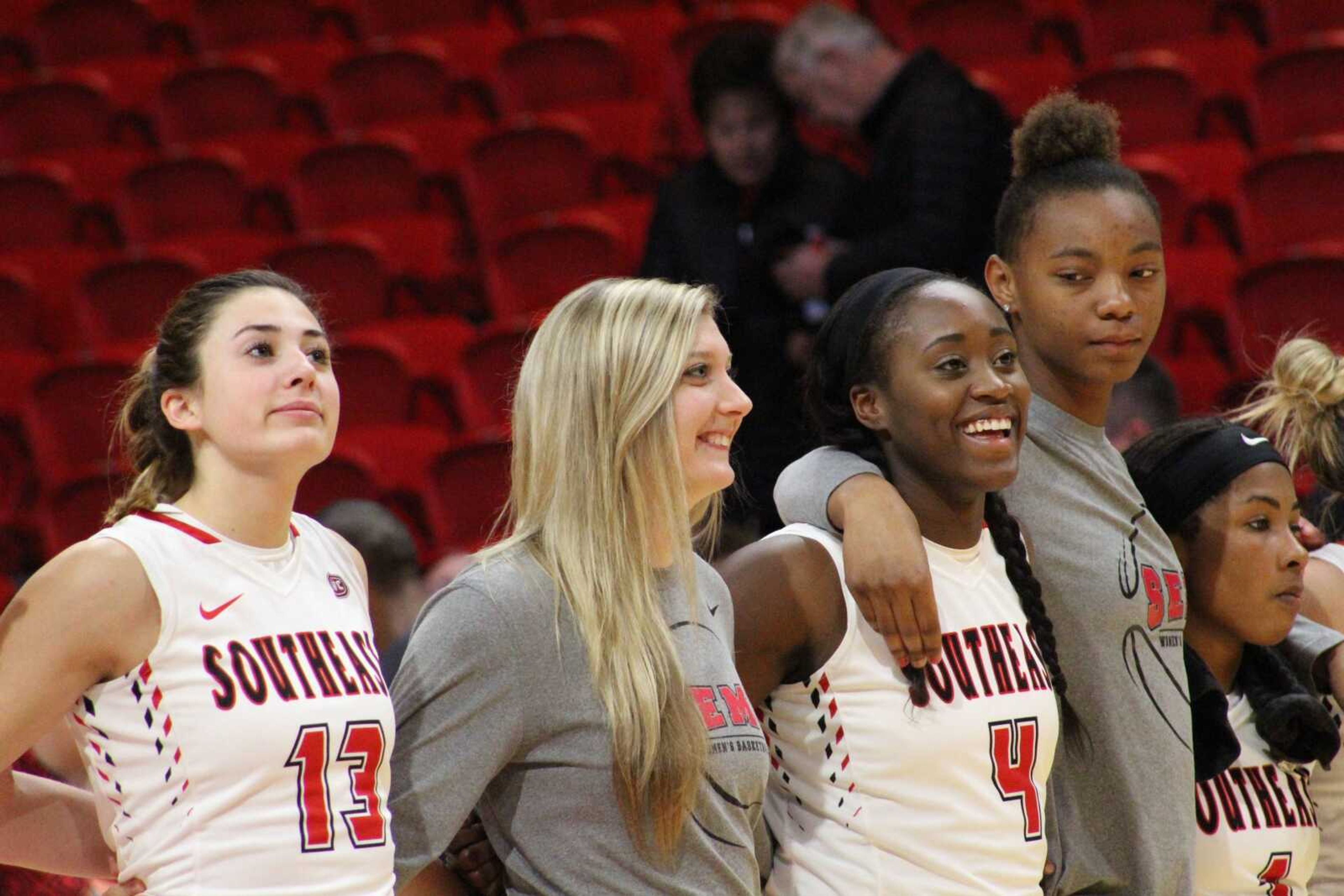 Sophomore guard Jessie Harshberger, No. 13, senior guard Kaley Leyhue and junior forward Dolapo Balogun, No. 4, stand on the court after the game on Nov. 14 against Missouri Valley to sing the Southeast Alma mater.