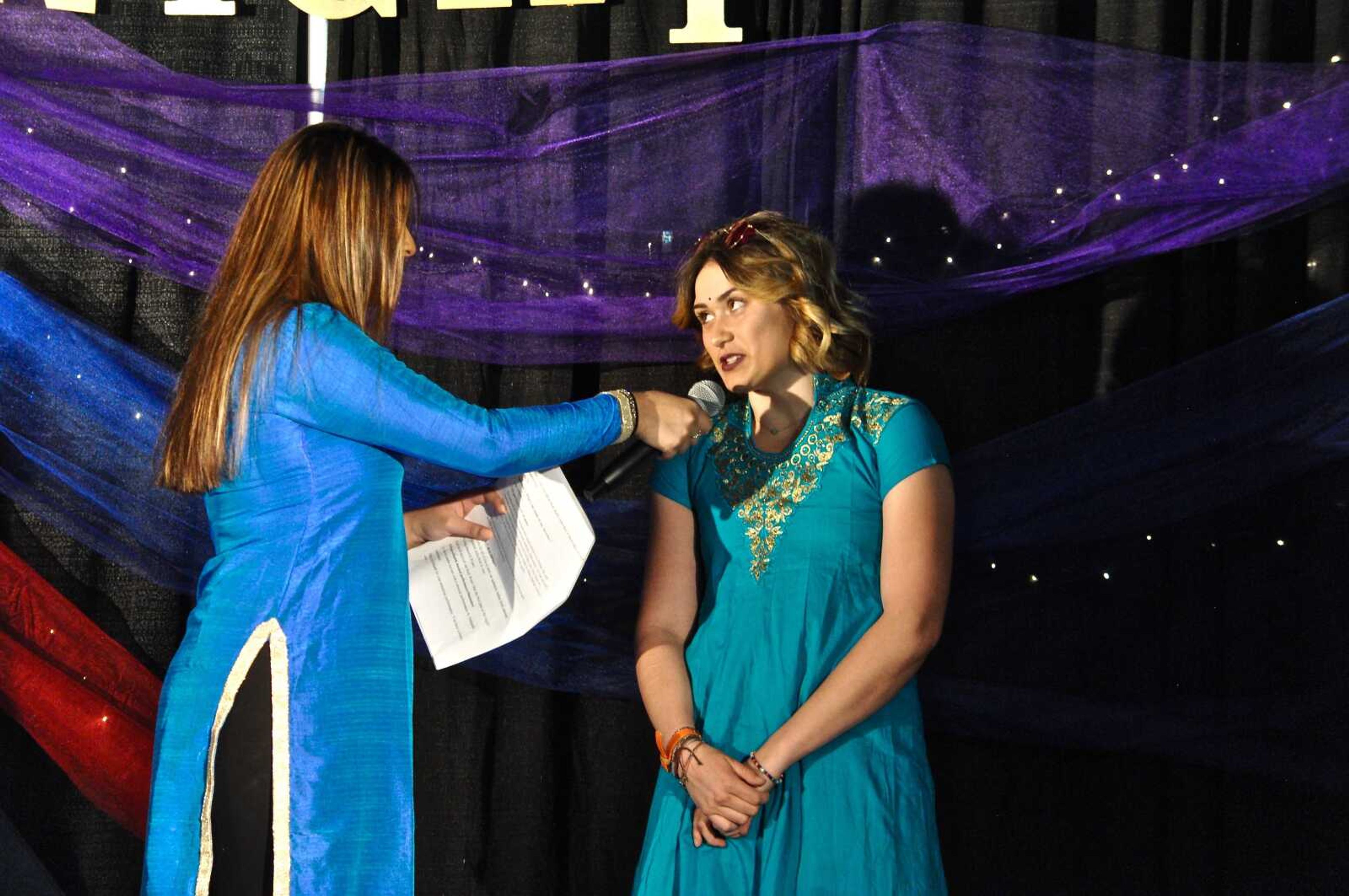 Southeast student Lexi Roelling speaks with Ruchika Sa, president of the International Student Association at Indian Night on March 23.