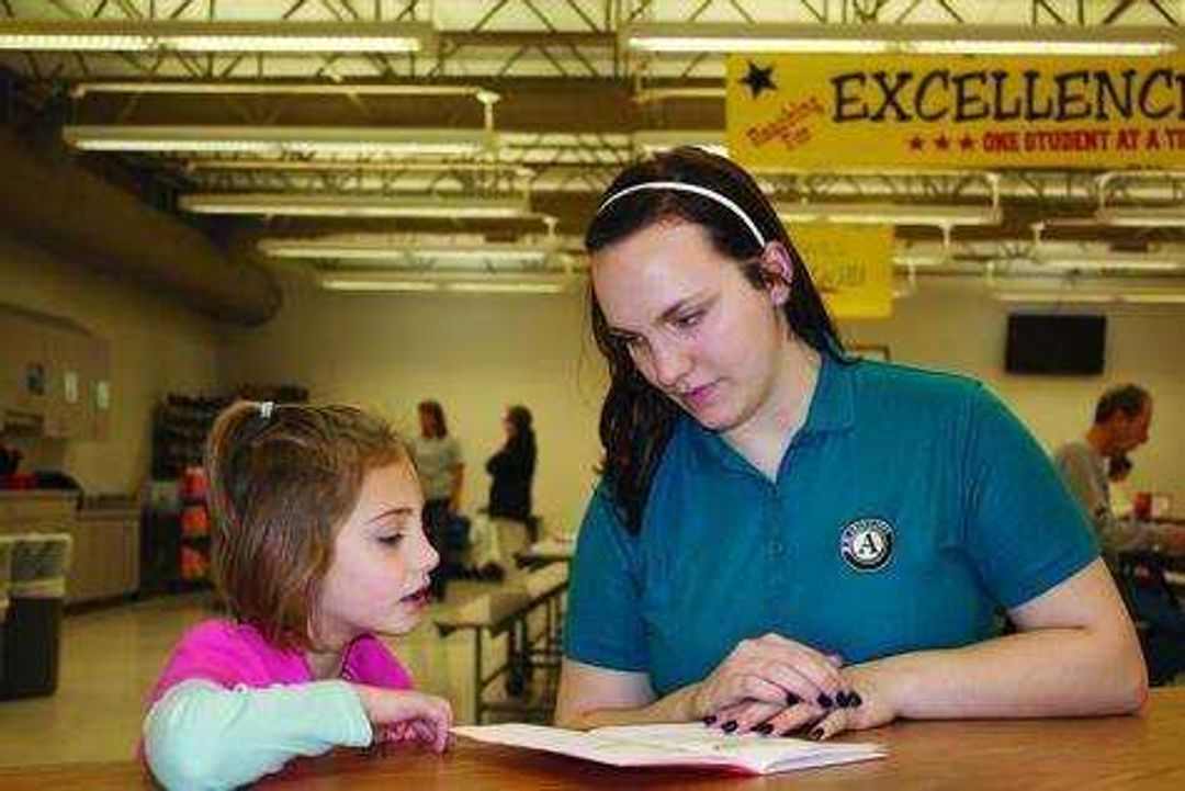 Elementary student Piper Underwood reads with mentor Southeast student Alicia Glenn at Clippard Elementary on Monday. Photo by Lauren Fox