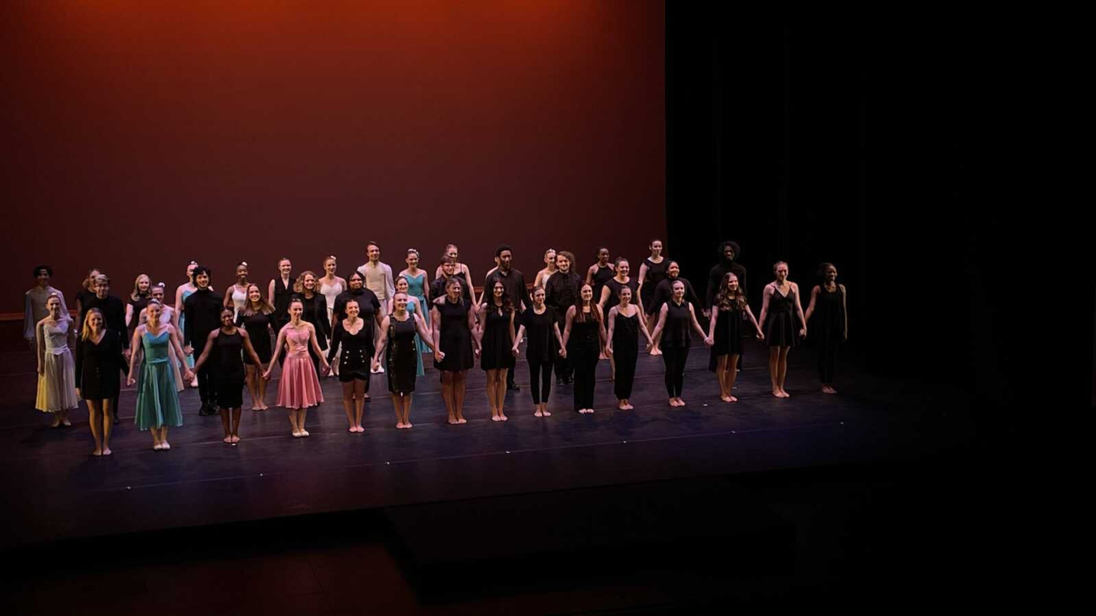 The dancers from Spring into Dance stand as the audience applauds their performance. The performance opened at 7:30 p.m. on Thursday, April 7.