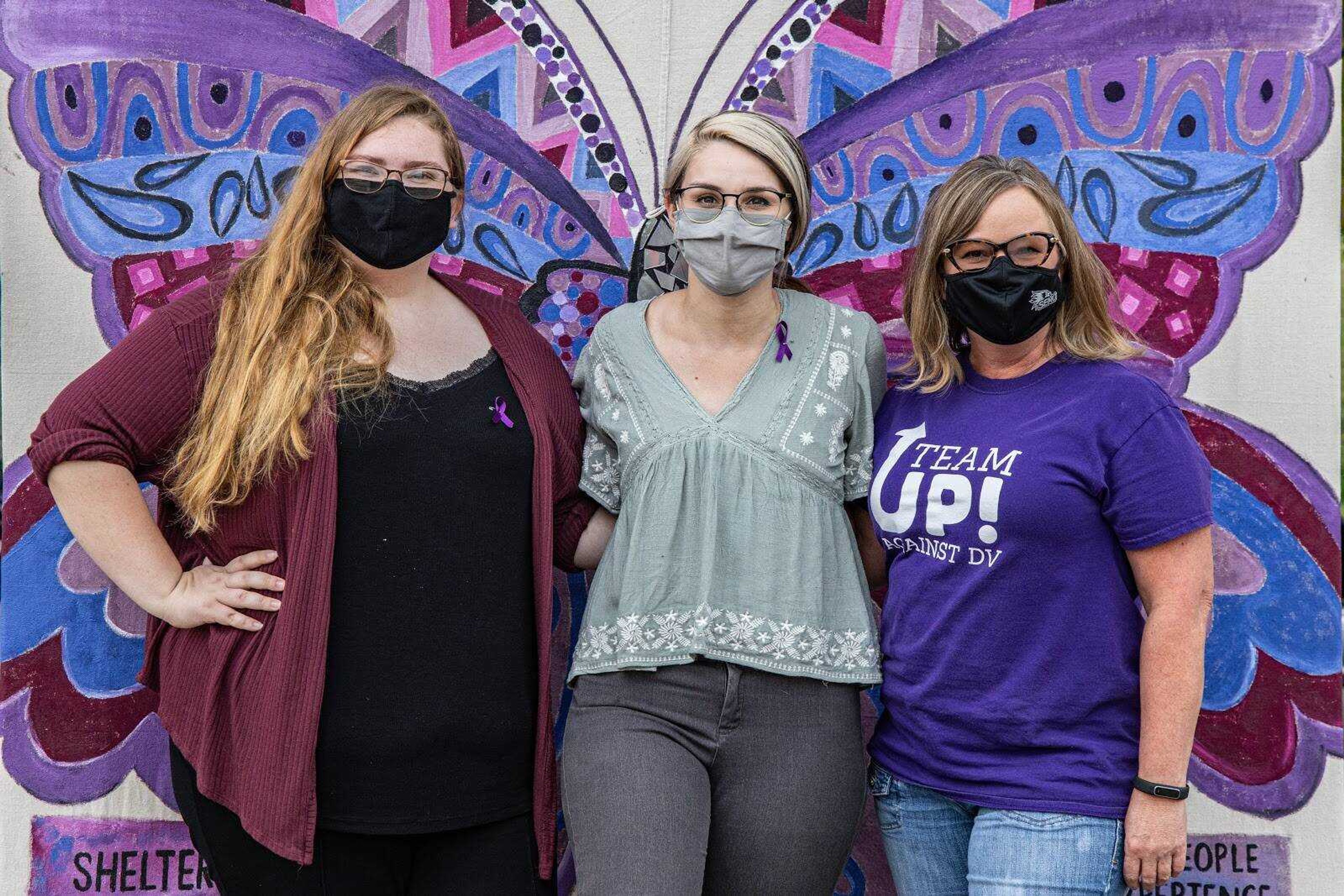 Sydney Tippitt- Lock (Left), Emily Heinlein (Middle) and Donna St. Sauver (Right), come together to display t-shirts decorated by survivors of domestic and dating violence in the campus community.