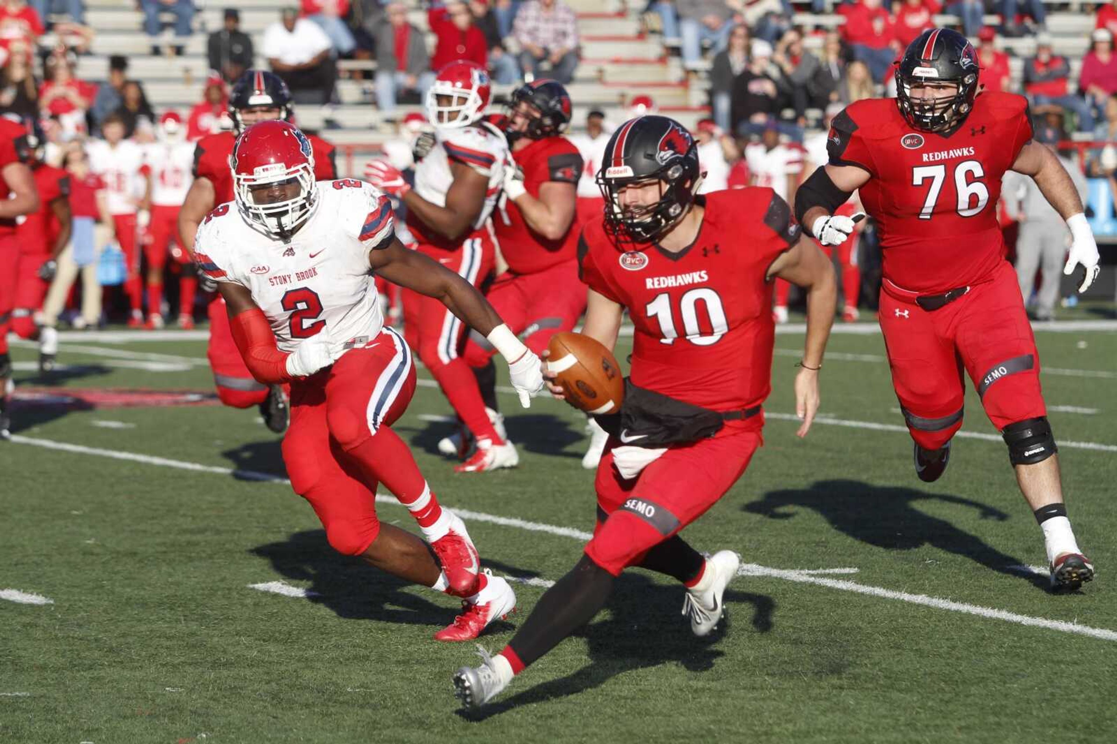 Junior quarterback Daniel Santacaterina weaves his way through Stony Brook's defense to get the Redhawks their first score of the game in the third quarter of a 28-14 playoff victory.