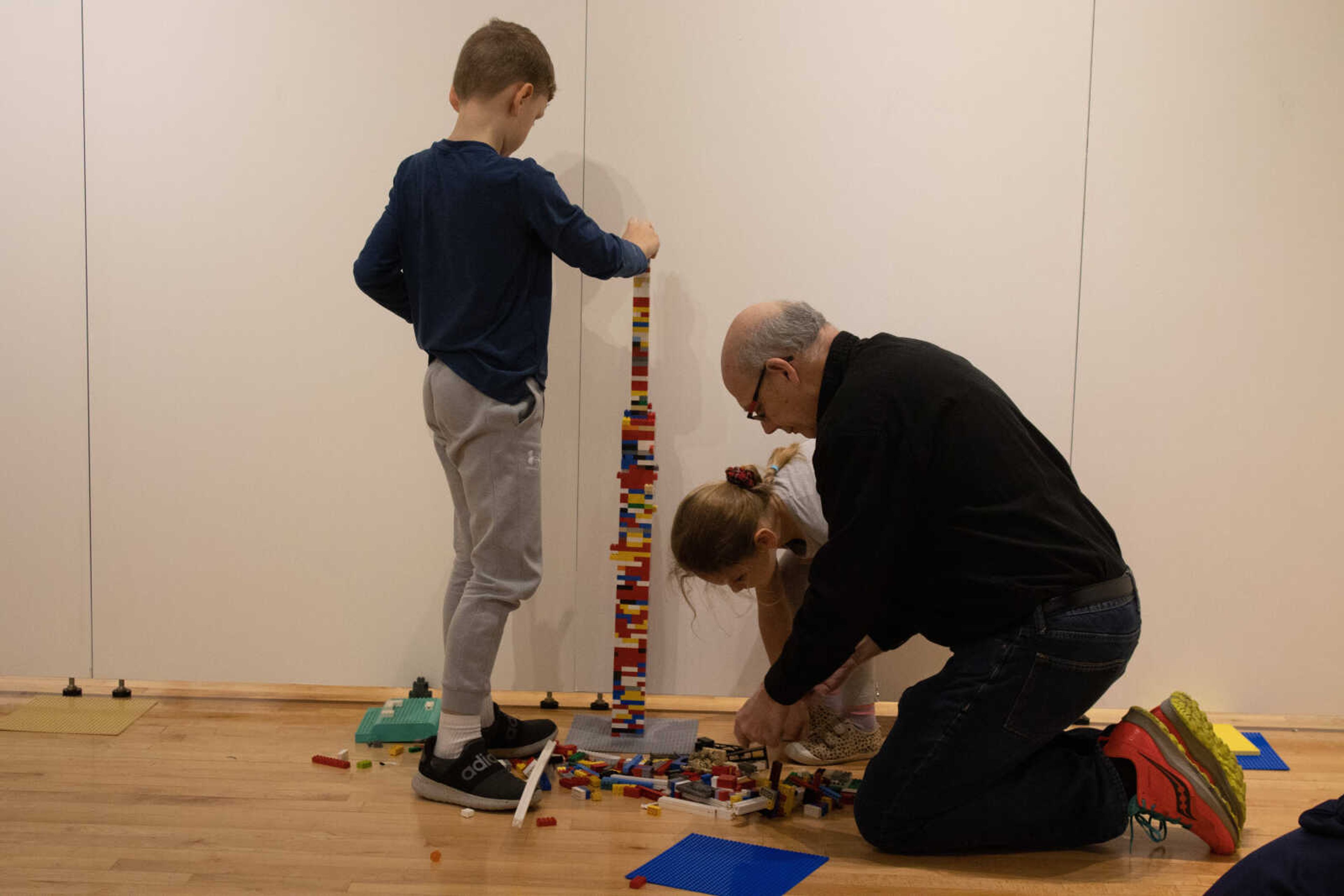 Outreach Specialist Gary Tyler and two children work to build the day one record breaking Lego tower, which stood at 88 inches tall. Their record was beaten on day two with a 92 inch tower built by three SEMO students, Bailee Porteous, Carlee Ashby and and Julia Vogt.