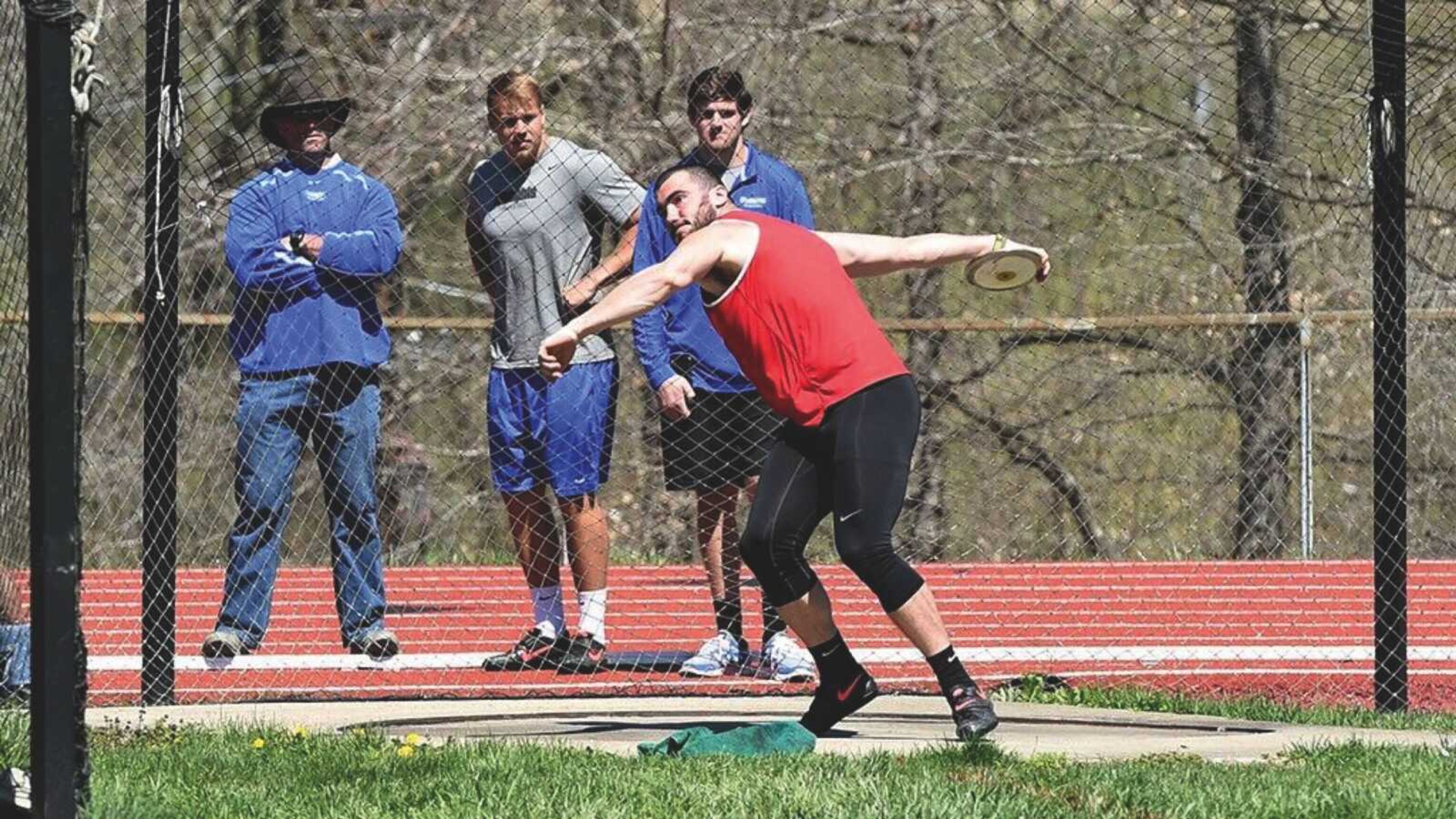 Senior thrower Jason Walker competes in the discus event of an outdoor track and field competition last season.