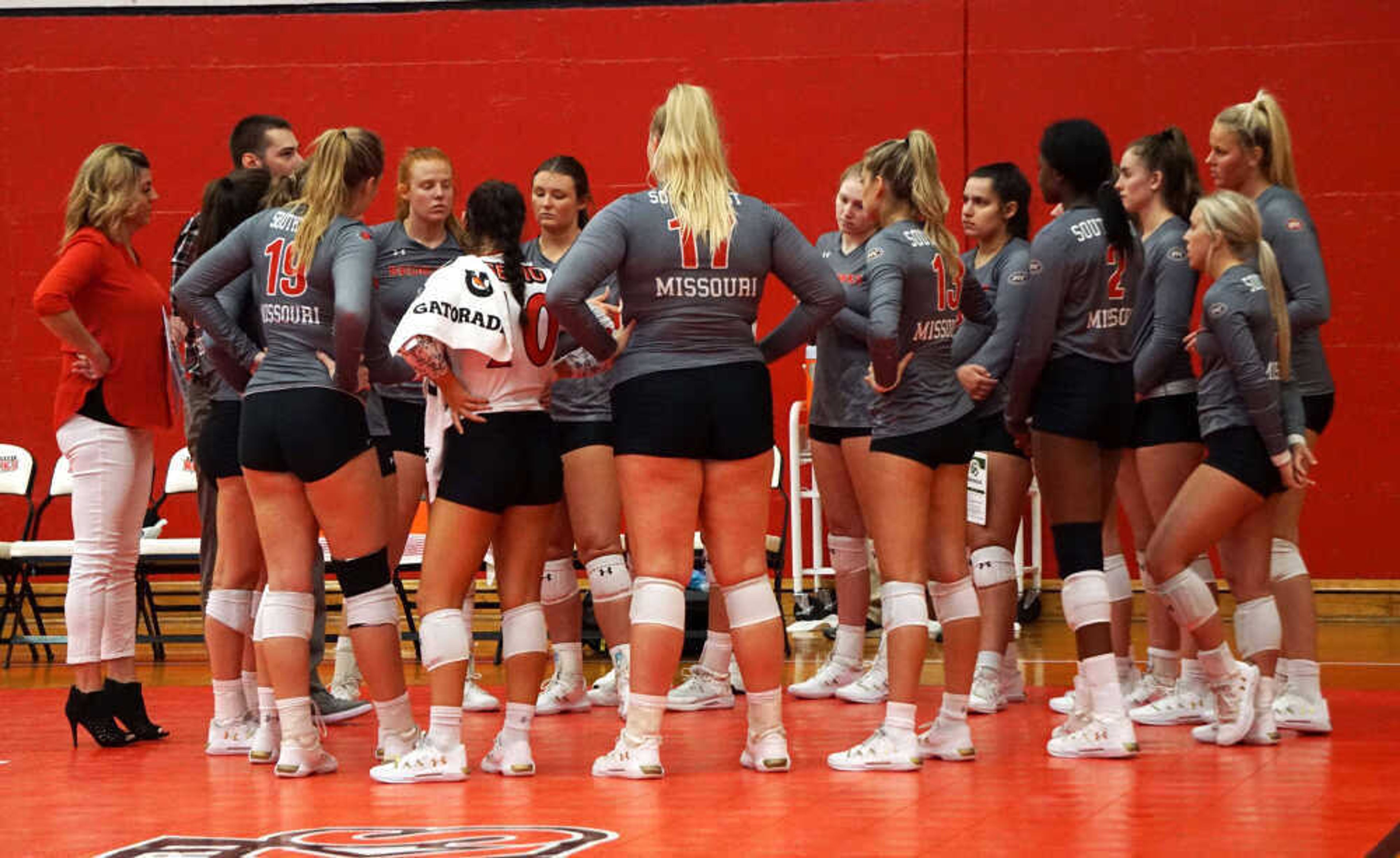 SEMO’s Volleyball team talks with Head Coach, Julie Yankus and Assistant Coach, Matt Stolz about strategies for the game during their five set loss to UT Martin on Sept. 29 at Houck Field House in Cape Girardeau.
