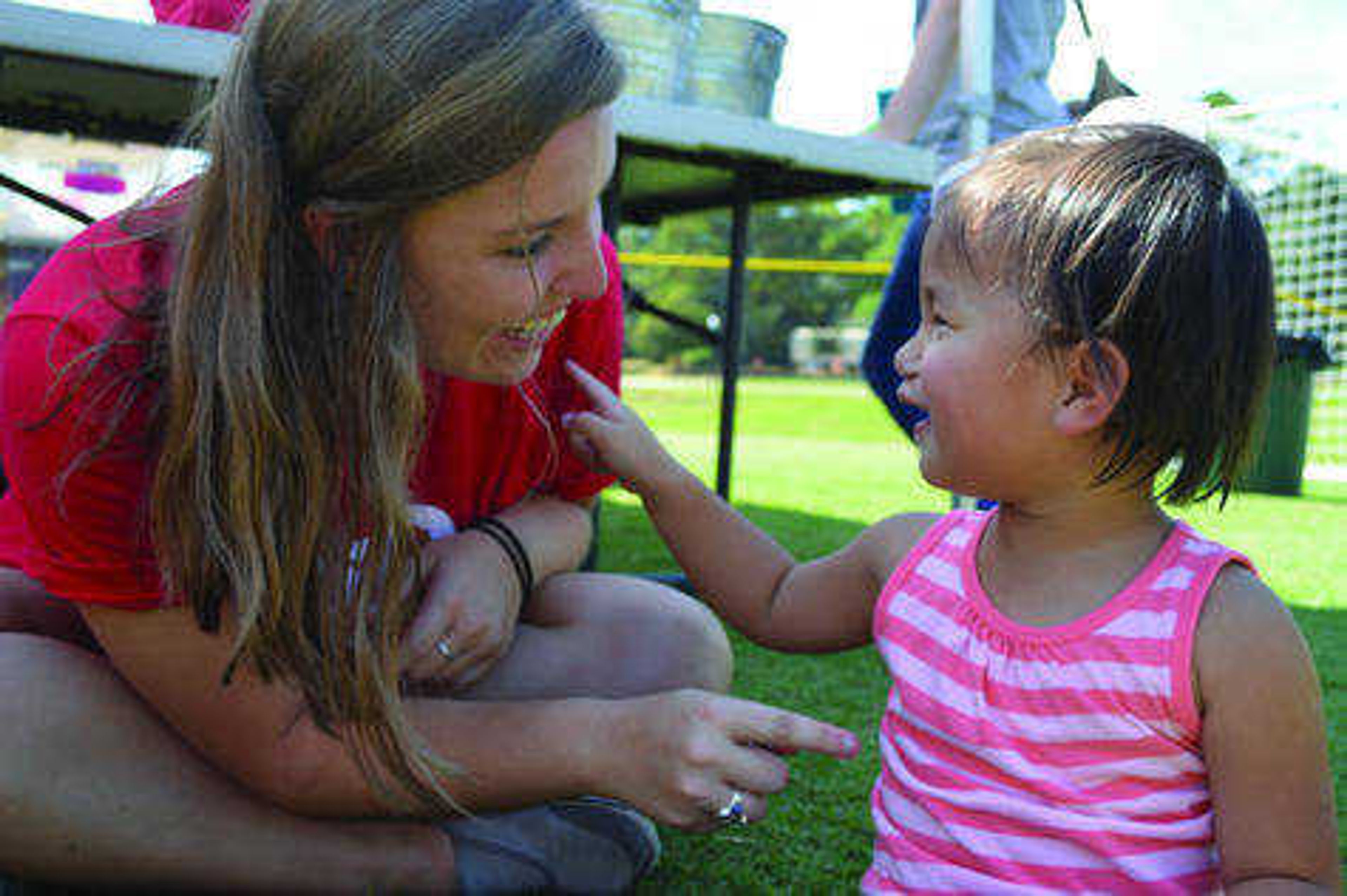 Kelly Lu Holder and a girl named Ellie, who was adopted, playing at Belhaven University during a Red Bus Project tour. Photo by Rebecca Foster.